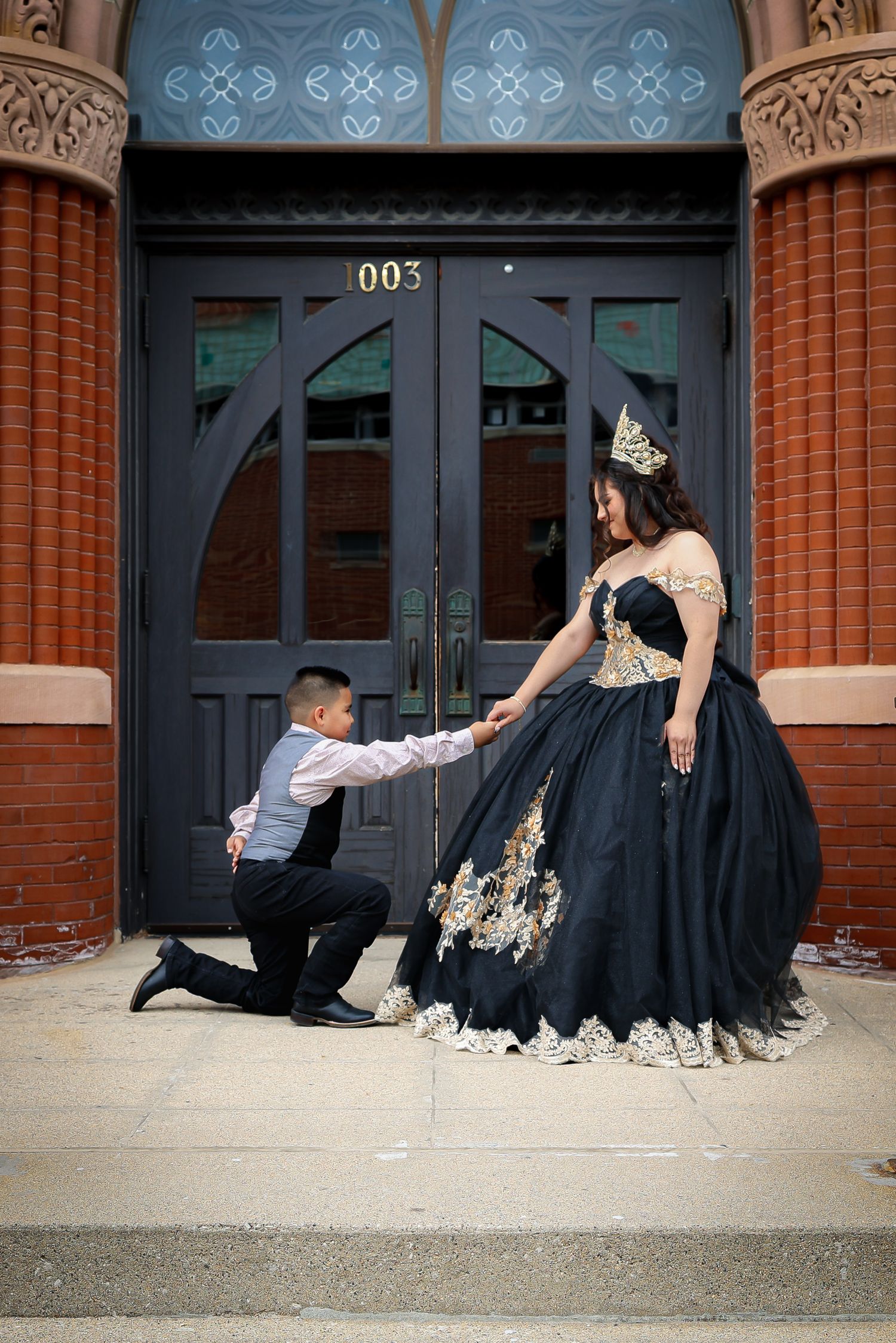 Elegant black and gold formal dress photographed in sequence on church steps.