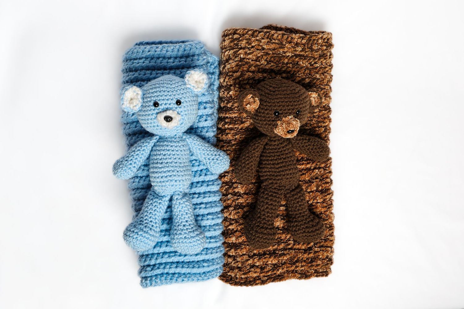 Crocheted teddy bears in light blue and brown colors displayed on white background.