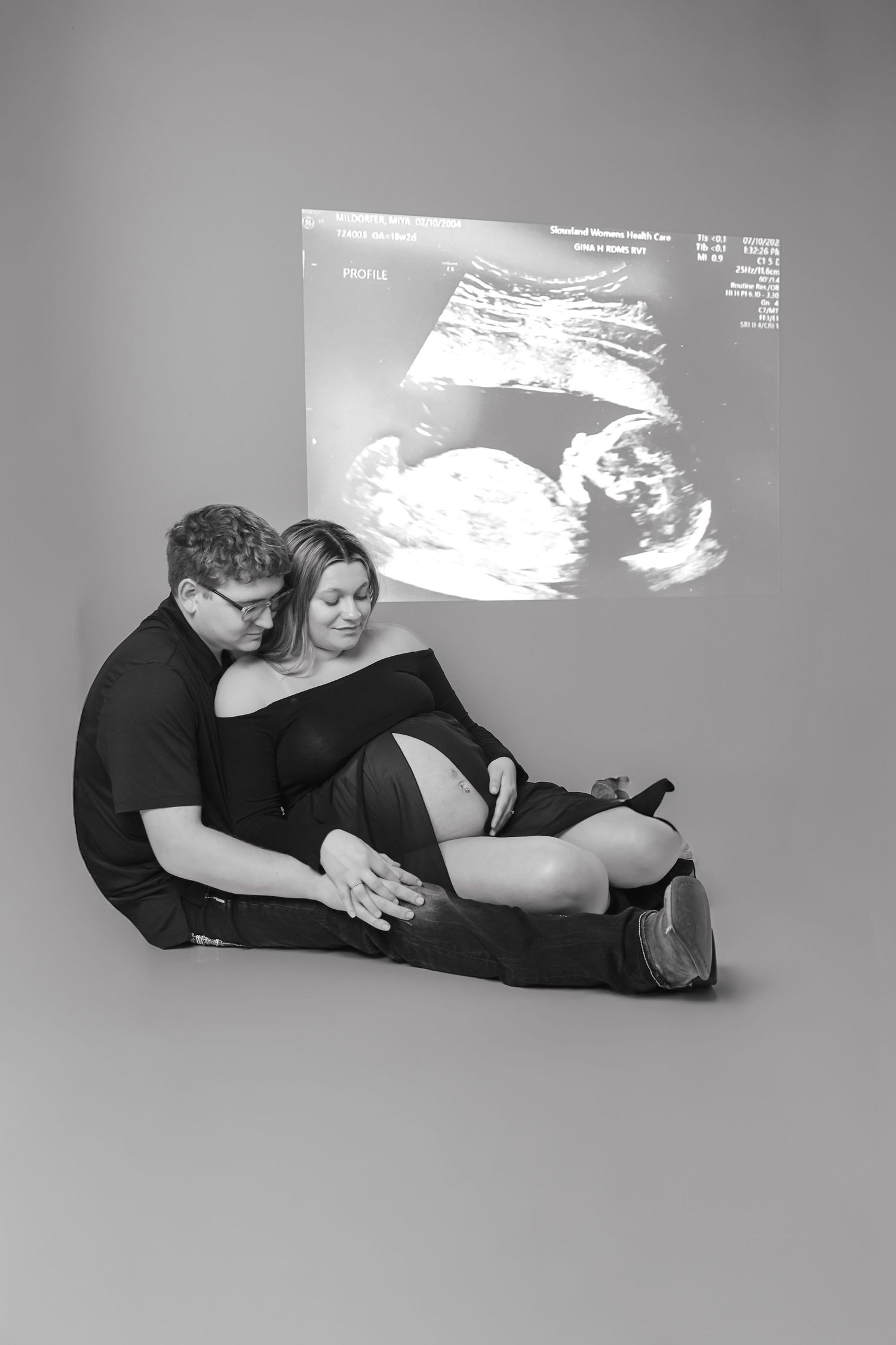 A series of black and white ultrasound images showing fetal development alongside artistic pregnancy portraits.