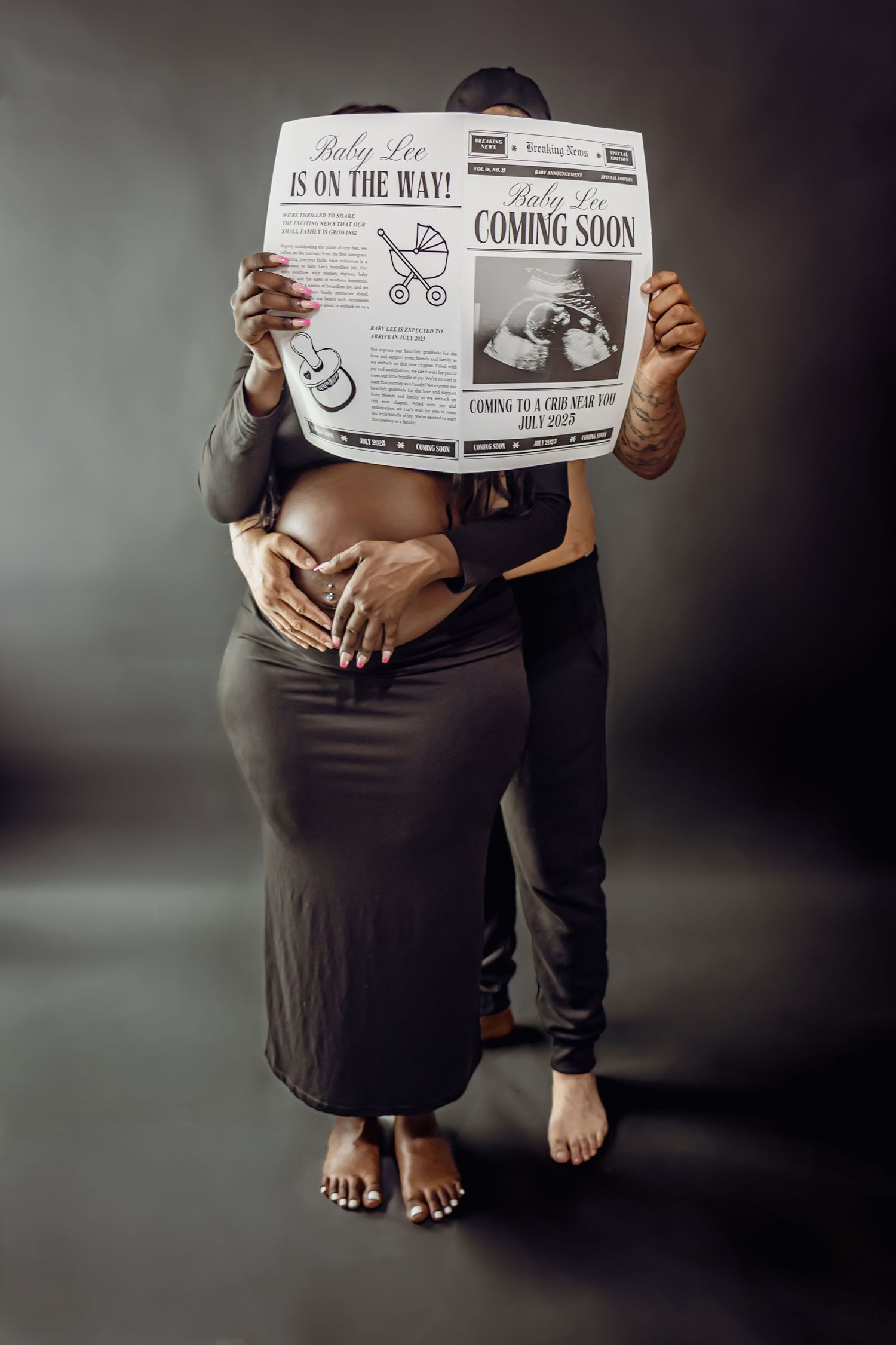 Expectant parents hold newspaper announcement showing 'Coming Soon' in artistic maternity photo.