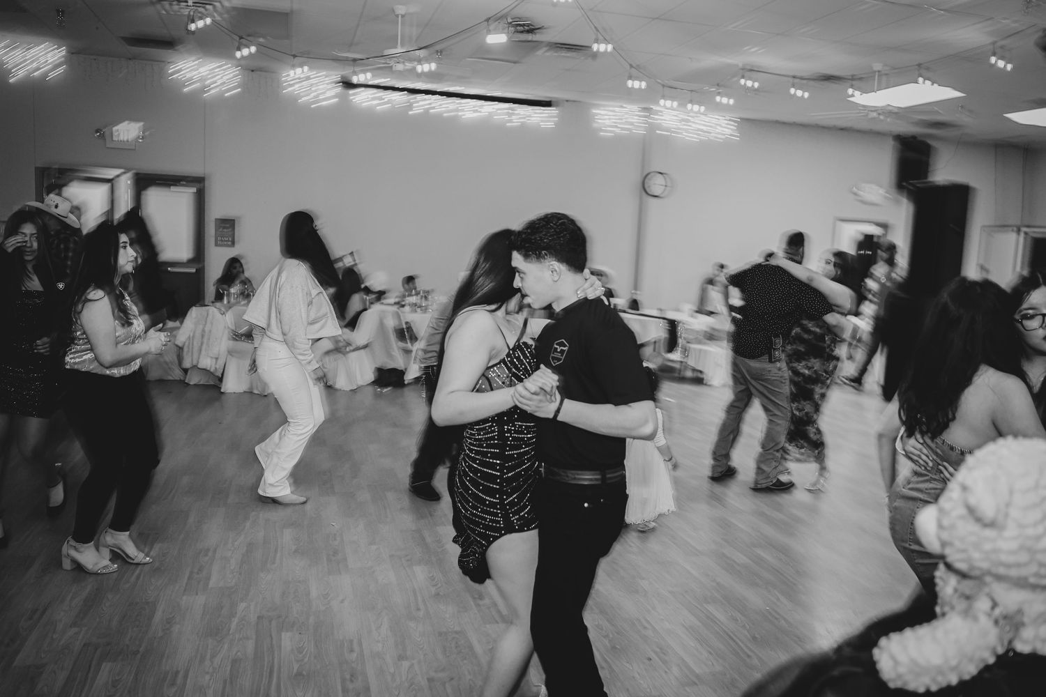 Black and white photos of dancing couples at a reception venue.