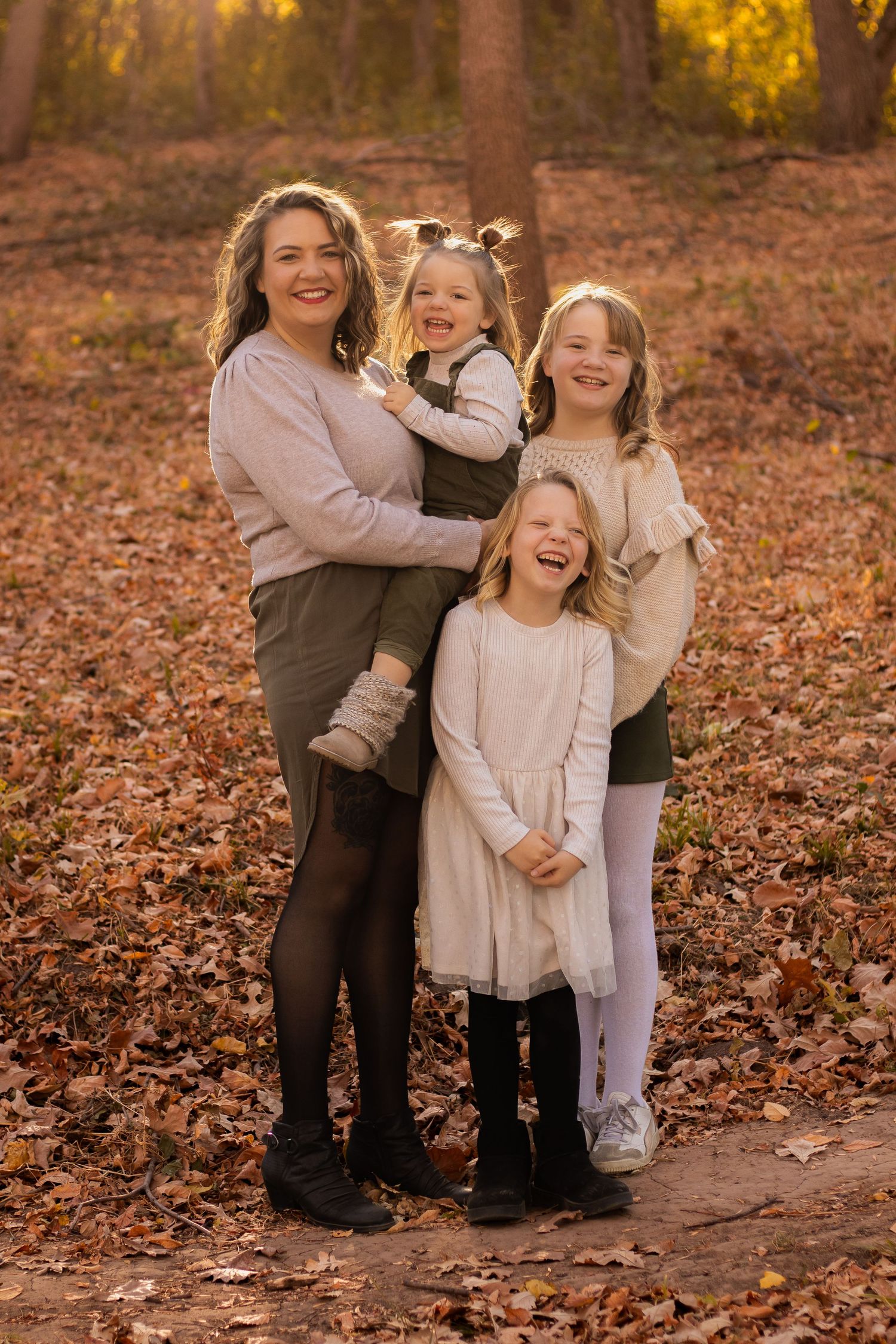 A joyful autumn photoshoot in a park with fallen leaves and warm golden light creating a cozy seasonal atmosphere.