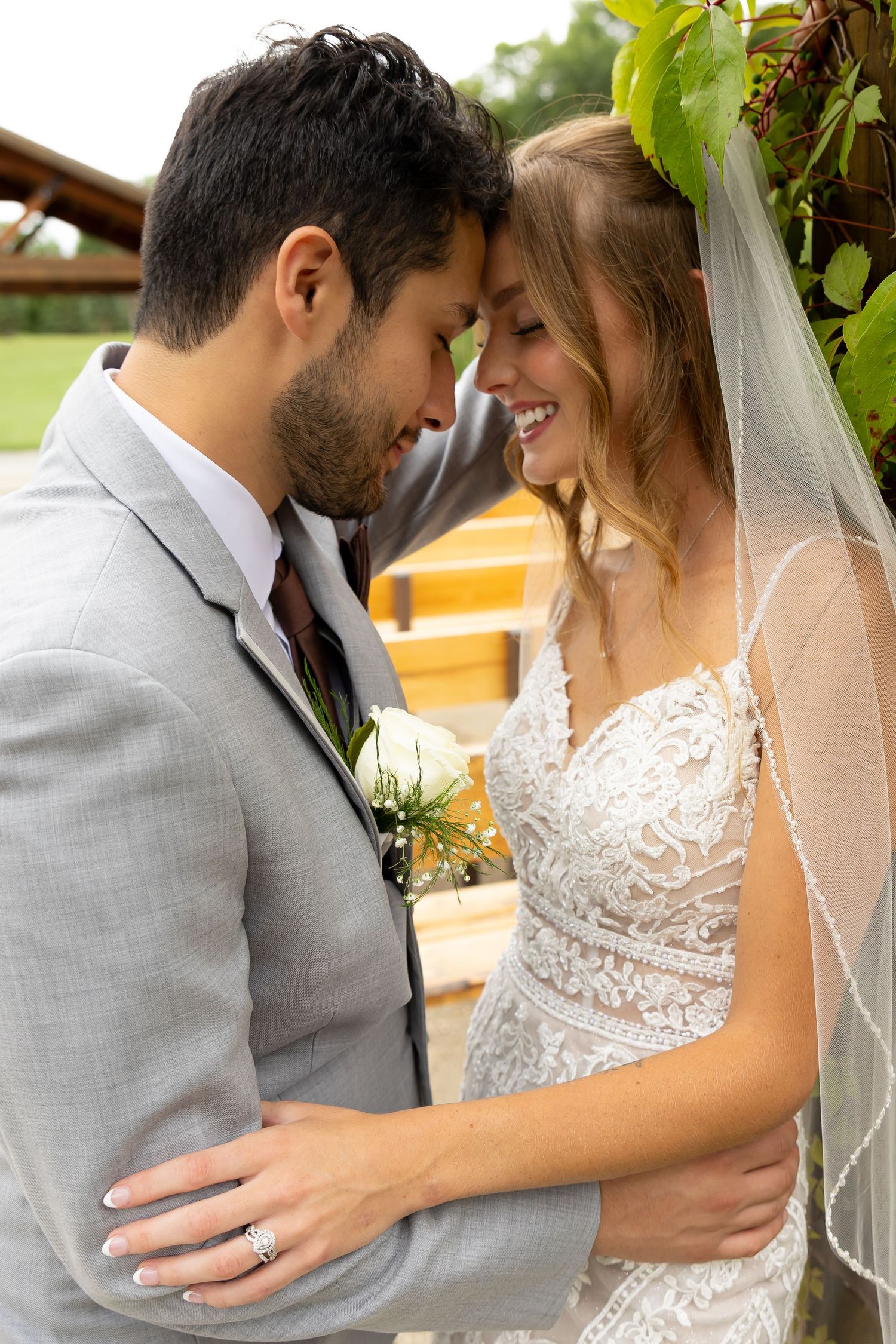 Romantic wedding couple embraces outdoors under green foliage in a series of intimate portrait shots.
