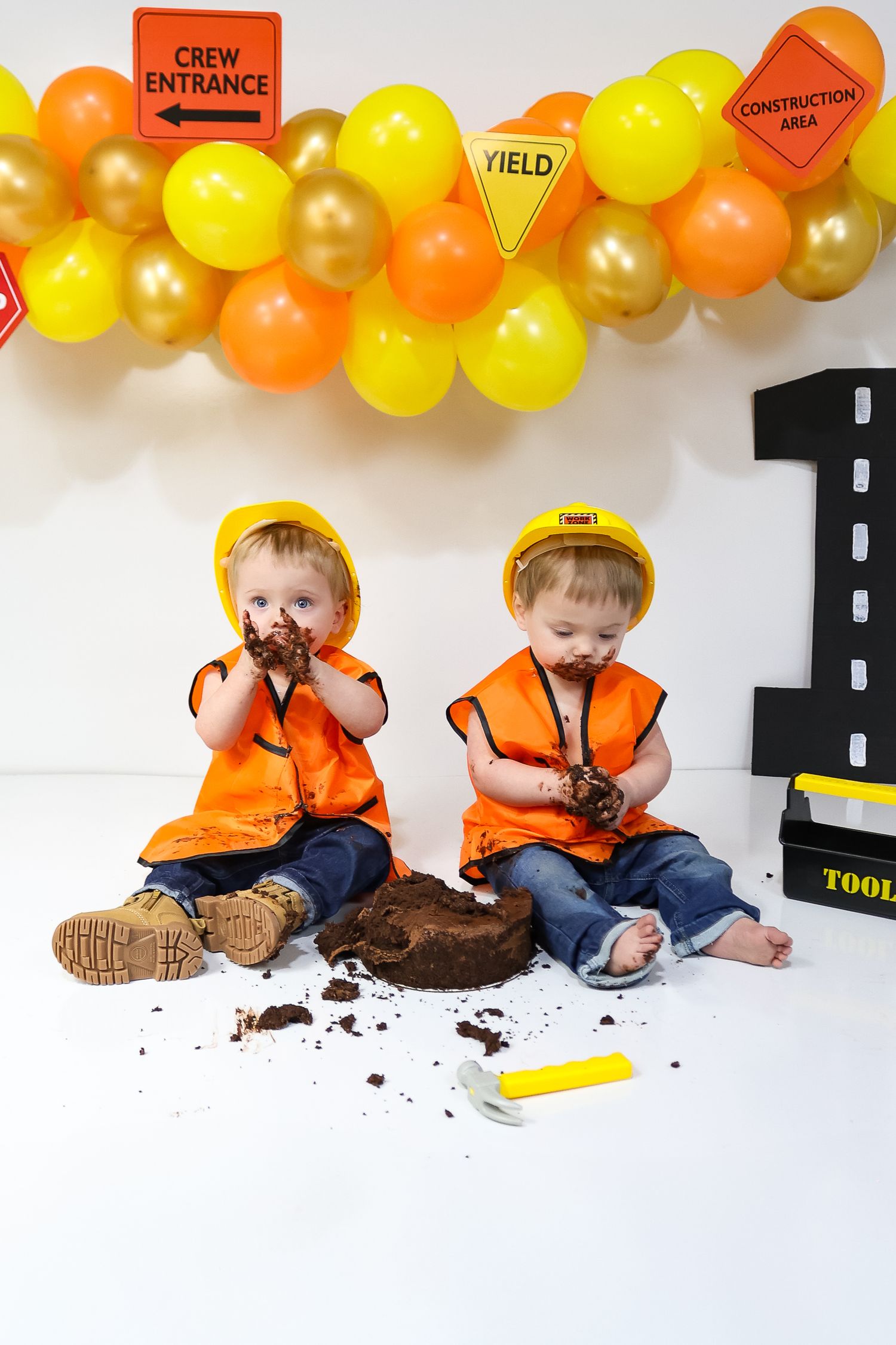 Construction themed birthday setup with safety signs and balloon decorations.