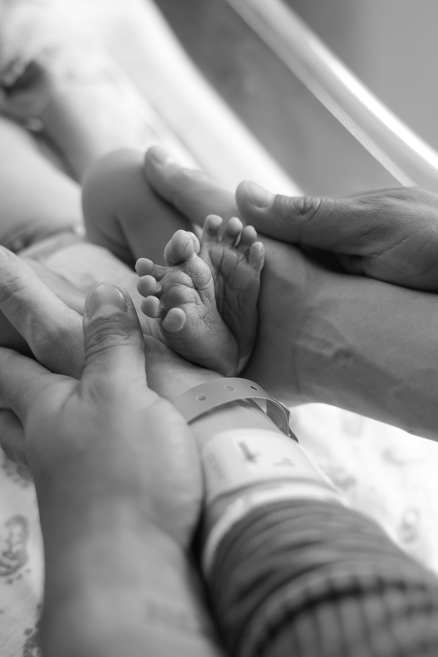 A series of black and white images showing gentle hand massage techniques on a person's foot during a spa treatment.