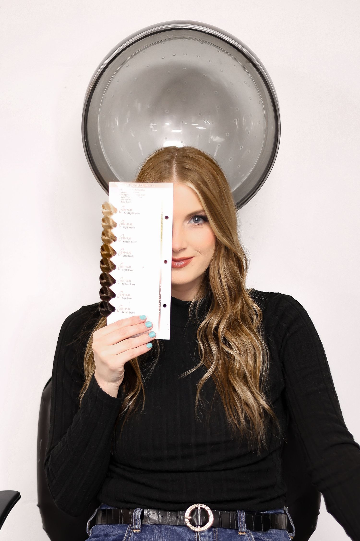 Person holding color swatches against light background.