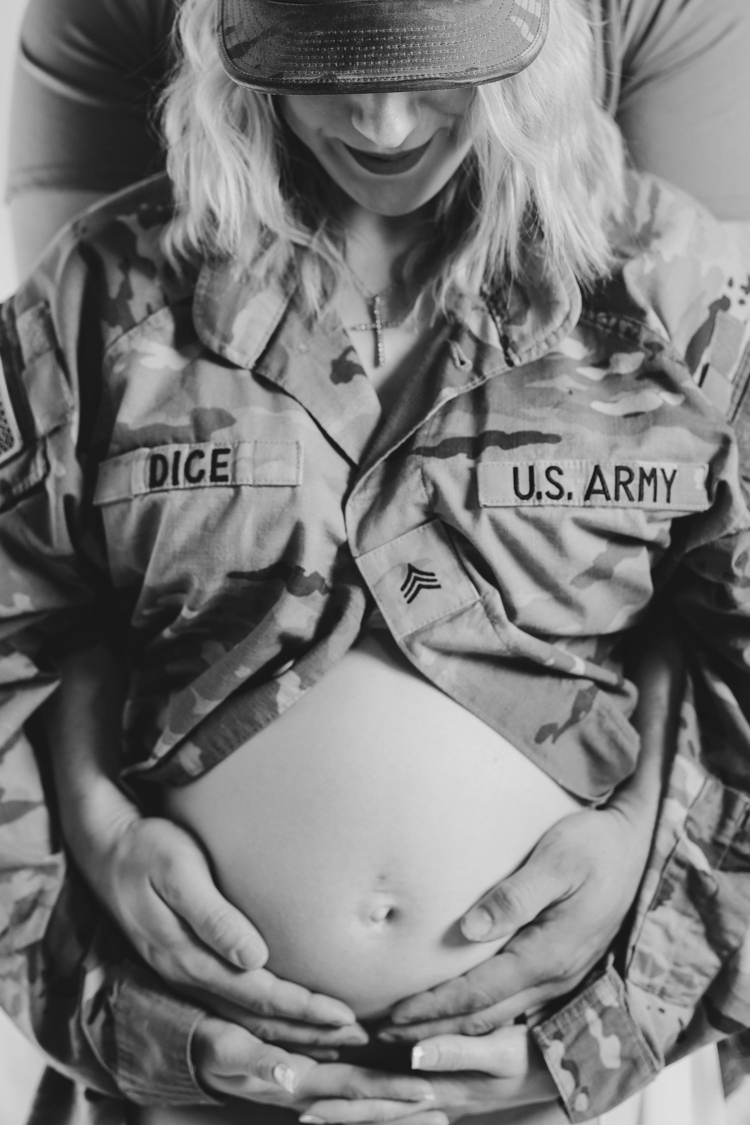 Black and white maternity photos in military uniform showing pregnancy progression.