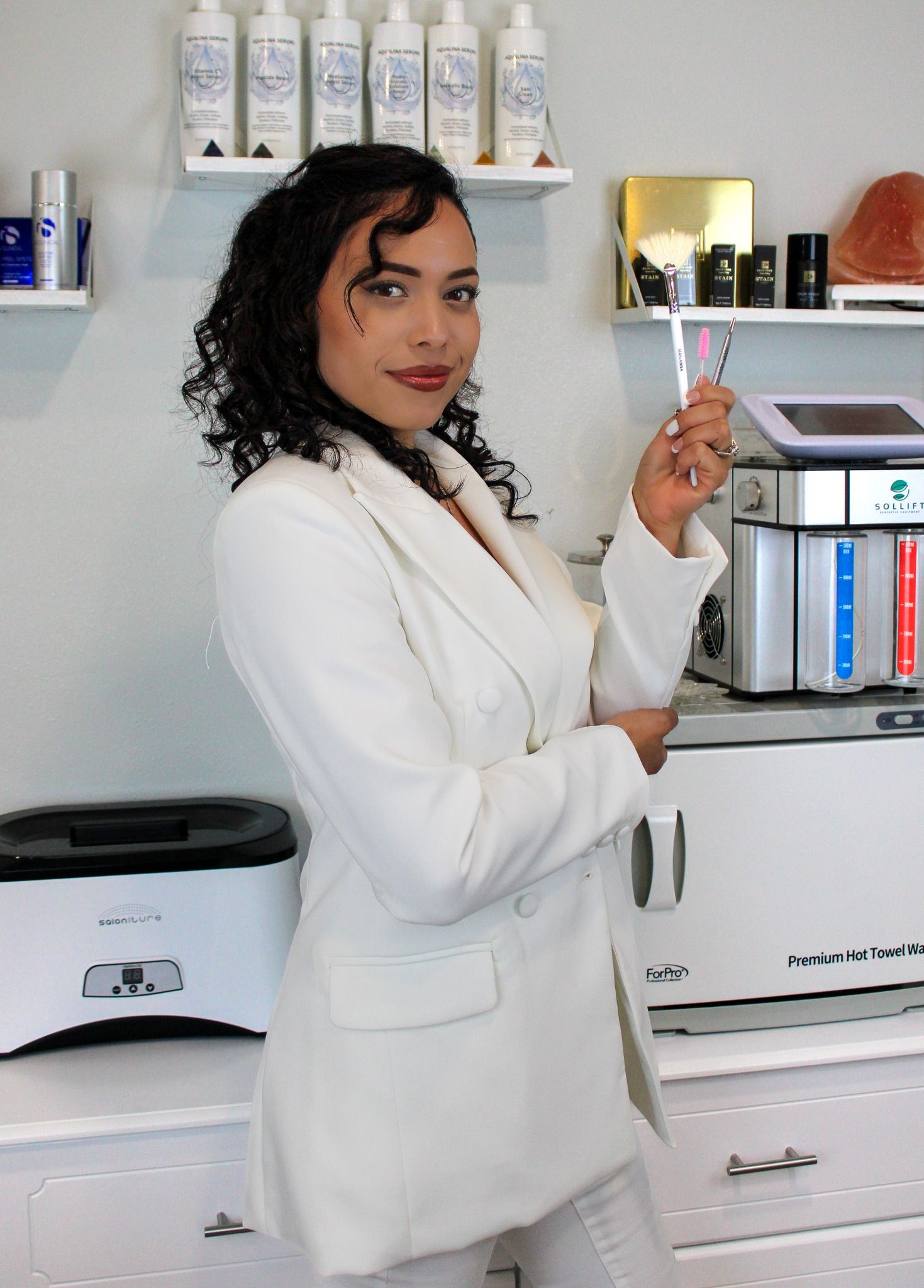 Professional wearing a white lab coat examines medical equipment in a laboratory setting.