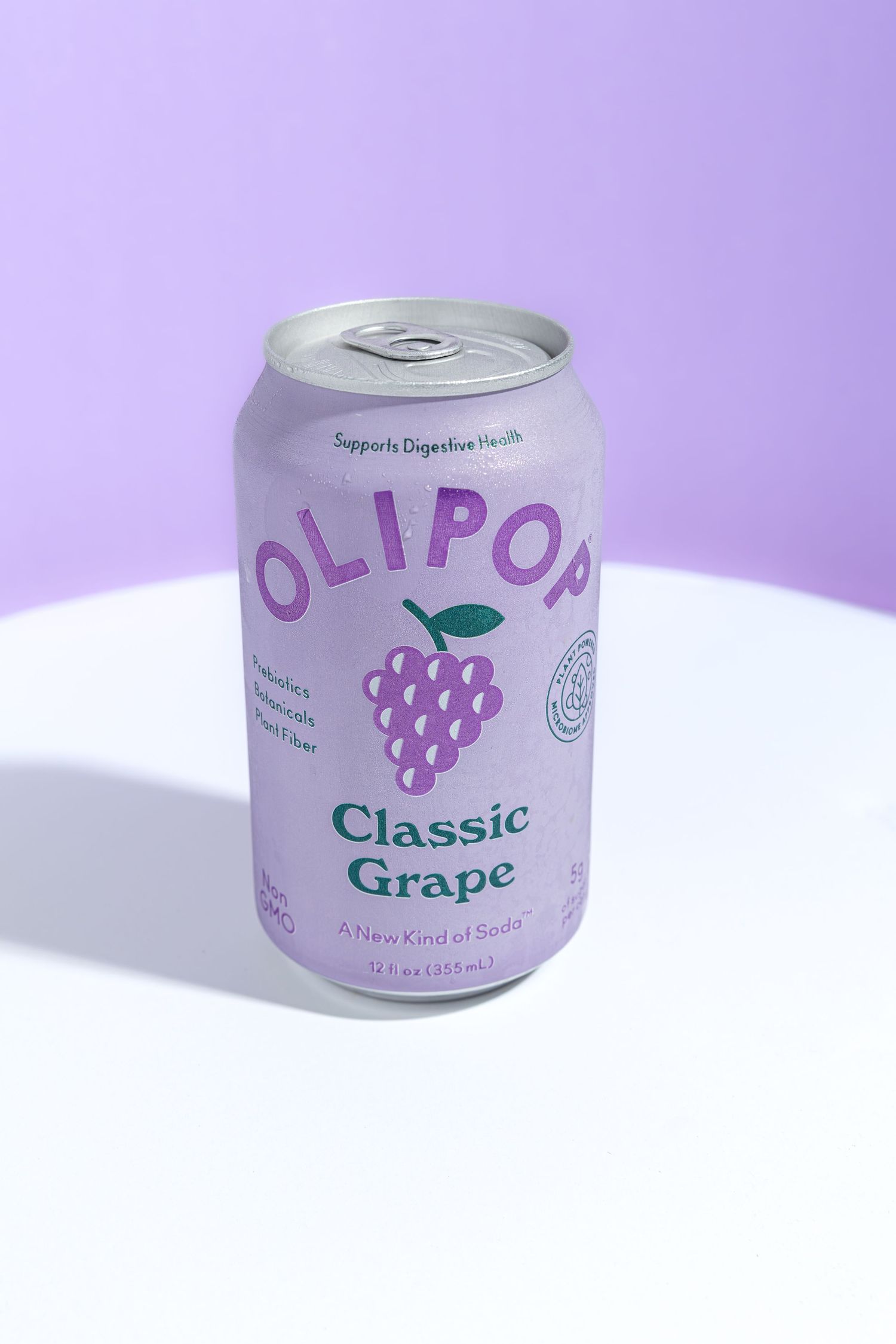 White aluminum can of grape-flavored beverage with purple text and grape illustration on a purple background.