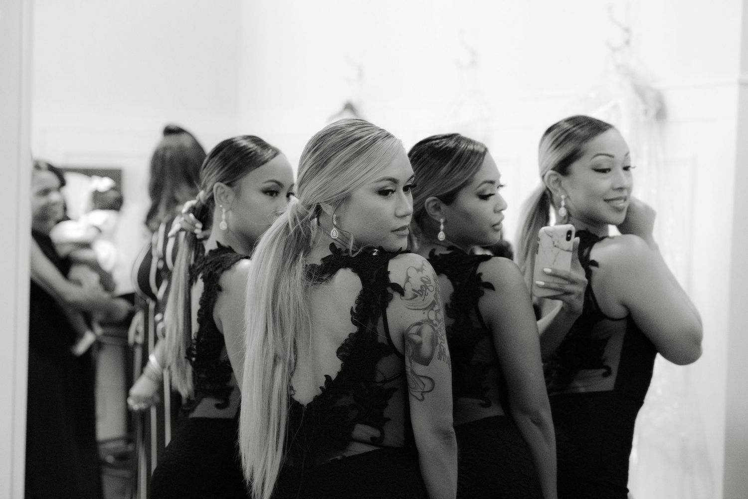 A series of candid black and white photos showing a group of bridesmaids getting ready for a wedding celebration.