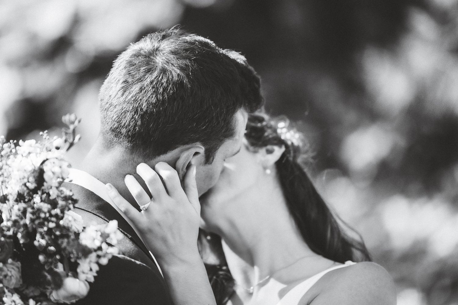 A series of black and white wedding photos showing romantic moments between newlyweds during their celebration.