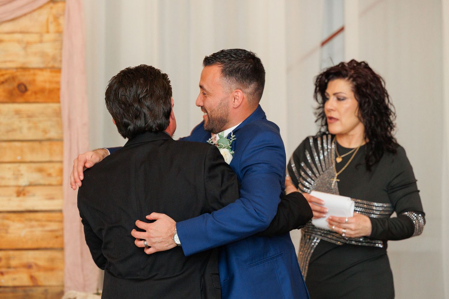 People sharing emotional embraces and hugs in a series of connected photos with wood paneled walls in the background.