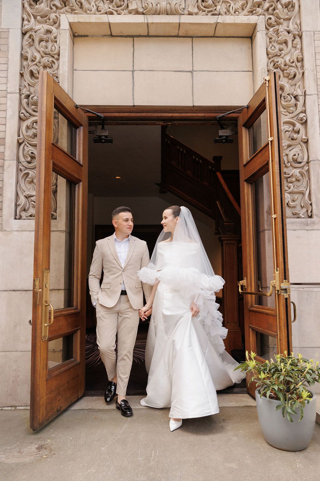 A series of wedding photos capturing moments outside an ornate stone building entrance.