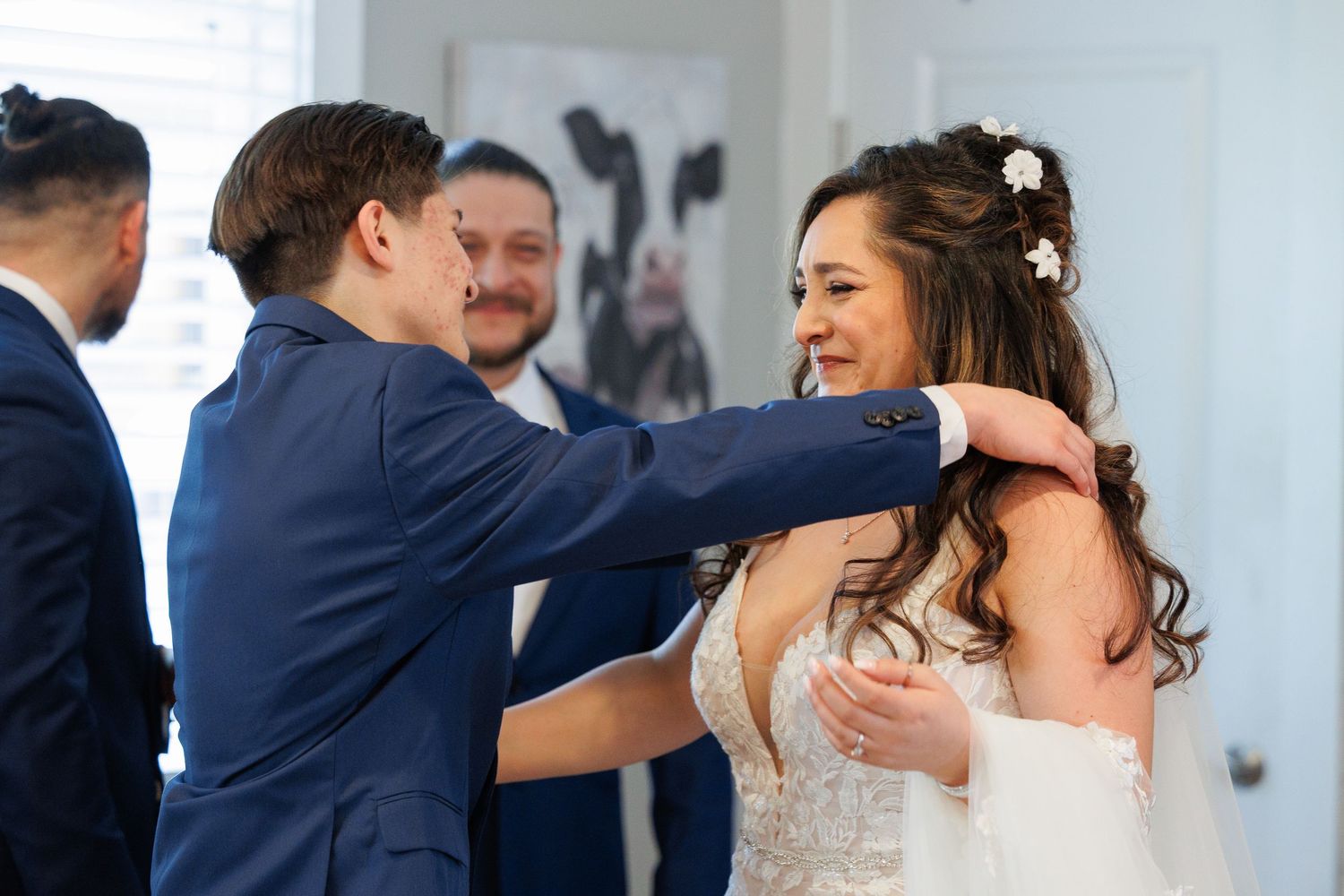 Wedding party members dance and celebrate together during an elegant reception in formal attire.