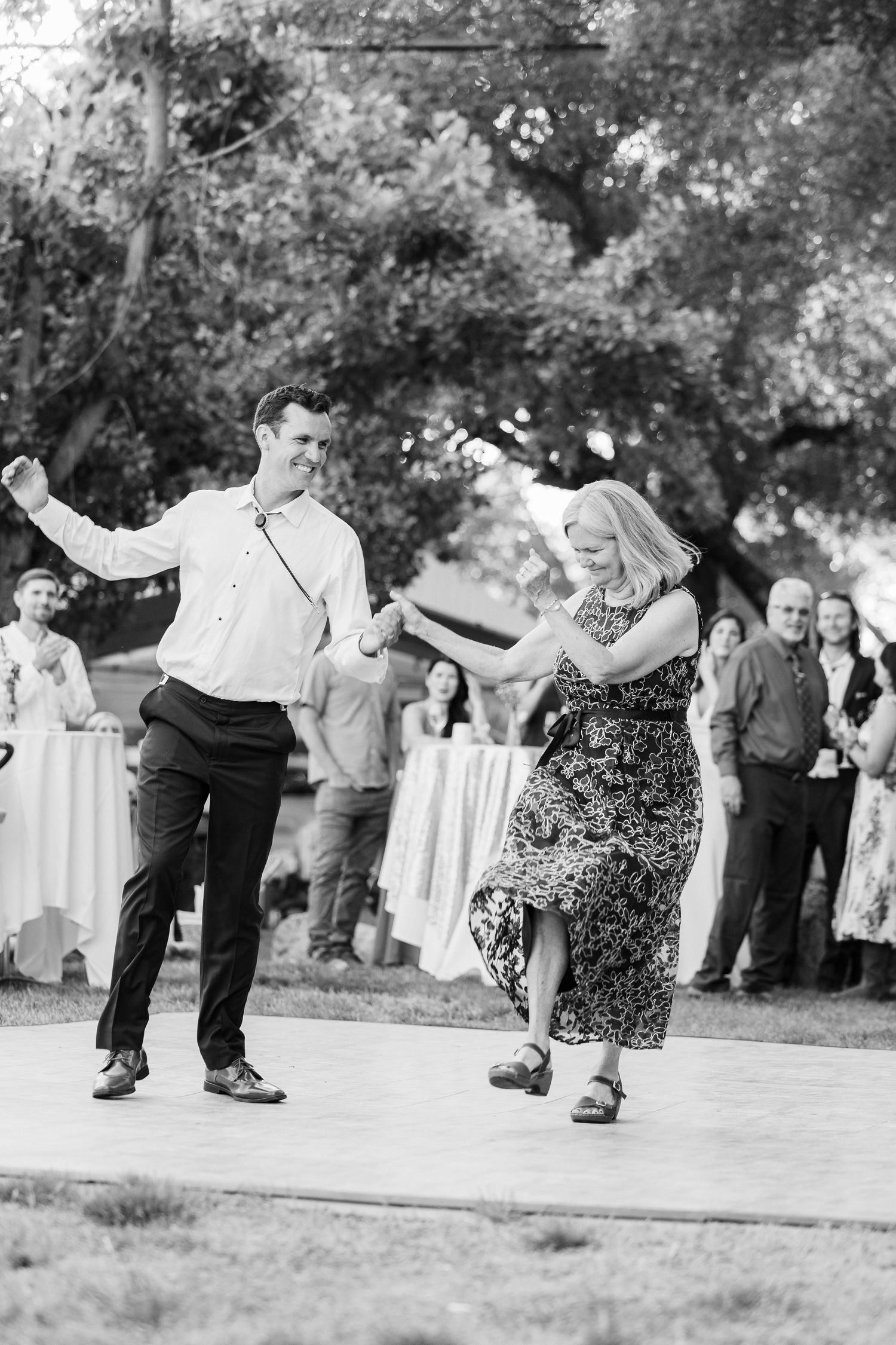 A series of black and white photos showing couples dancing together at an outdoor event.