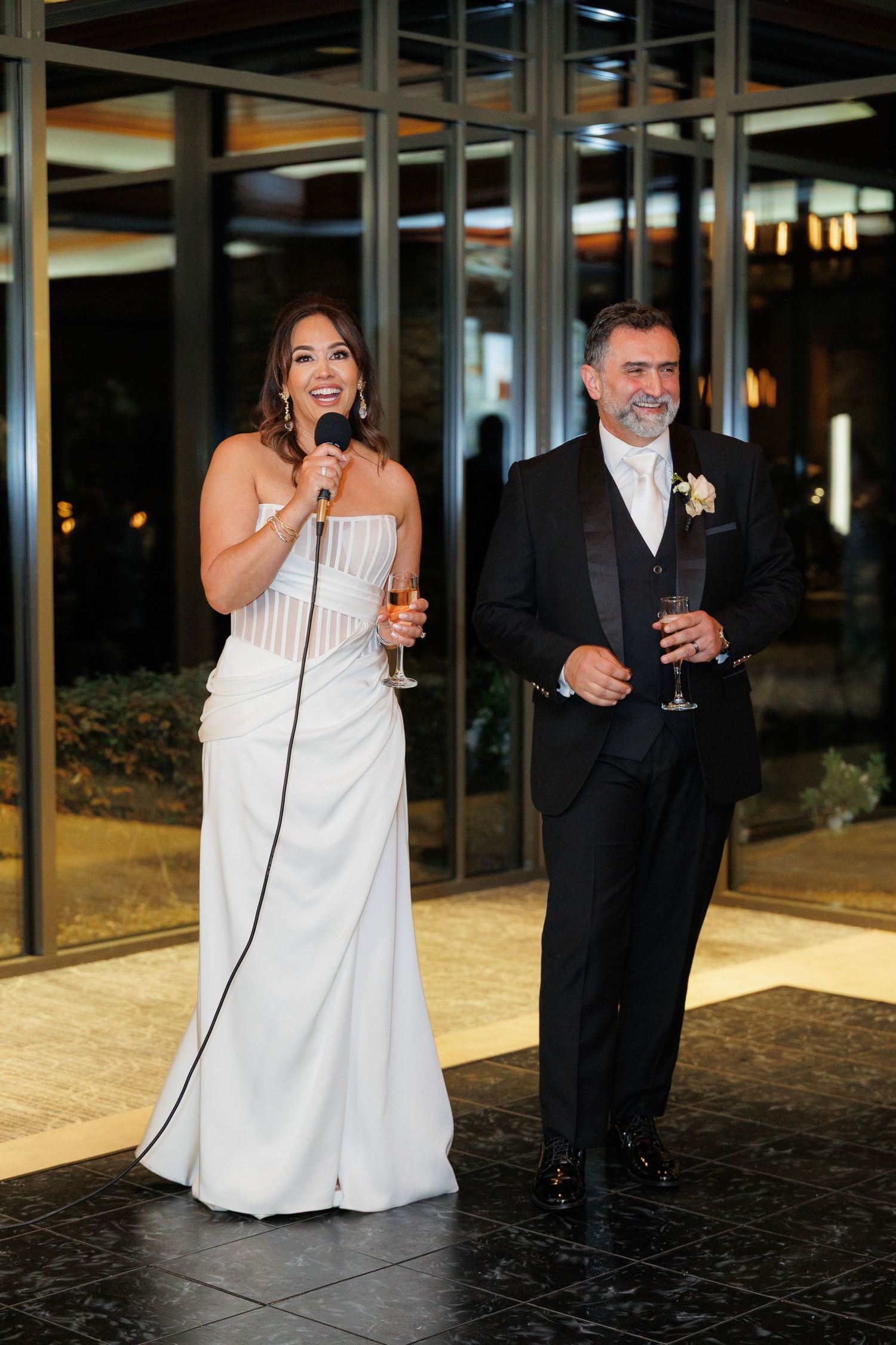 A bride and groom share a joyful moment while dancing together at their wedding reception.