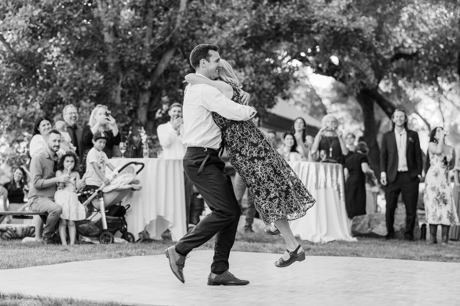Black and white wedding photos showing couples dancing outdoors at a garden reception celebration.