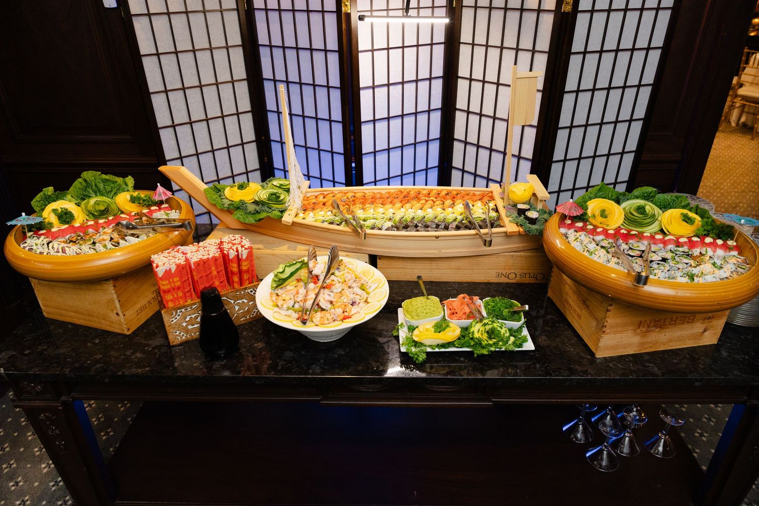 A variety of colorful appetizers and snacks arranged on wooden platters at a catering event.