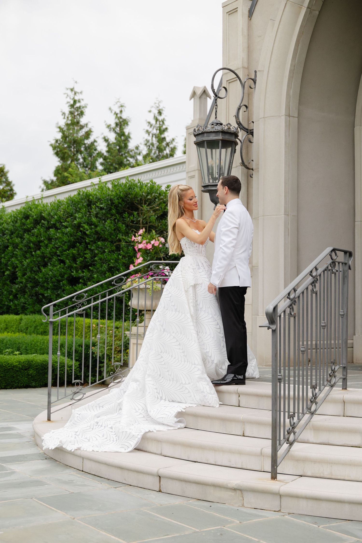 A couple in formal wedding attire descends elegant stone steps outside a building with ornate railings in a sequence of photos.