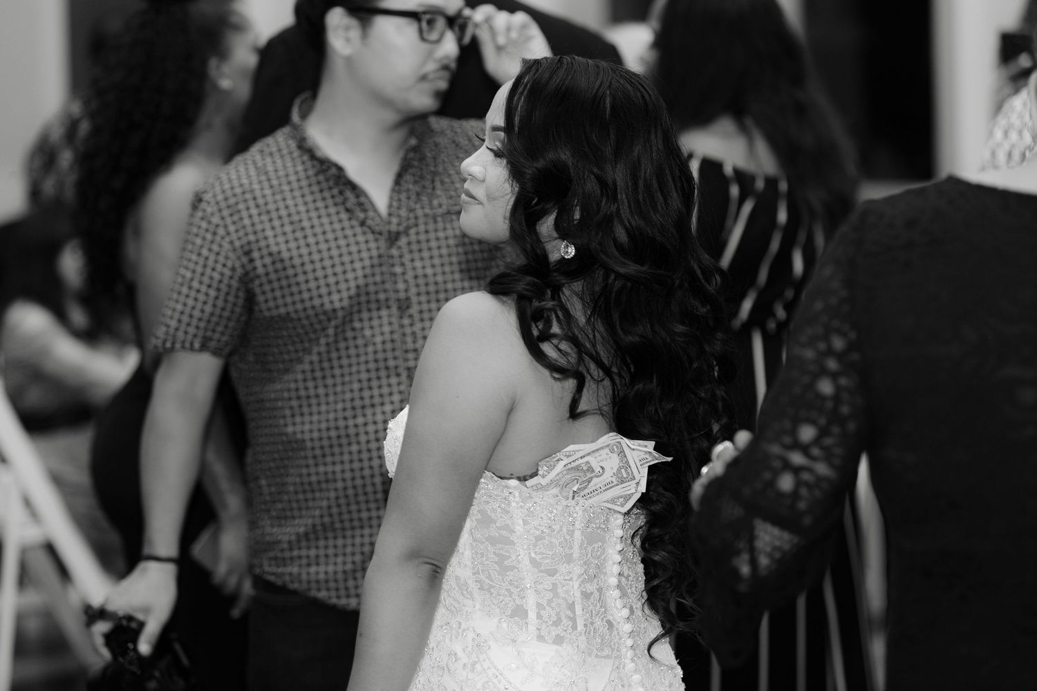 A black and white photo of a couple dancing together at a wedding reception celebration.