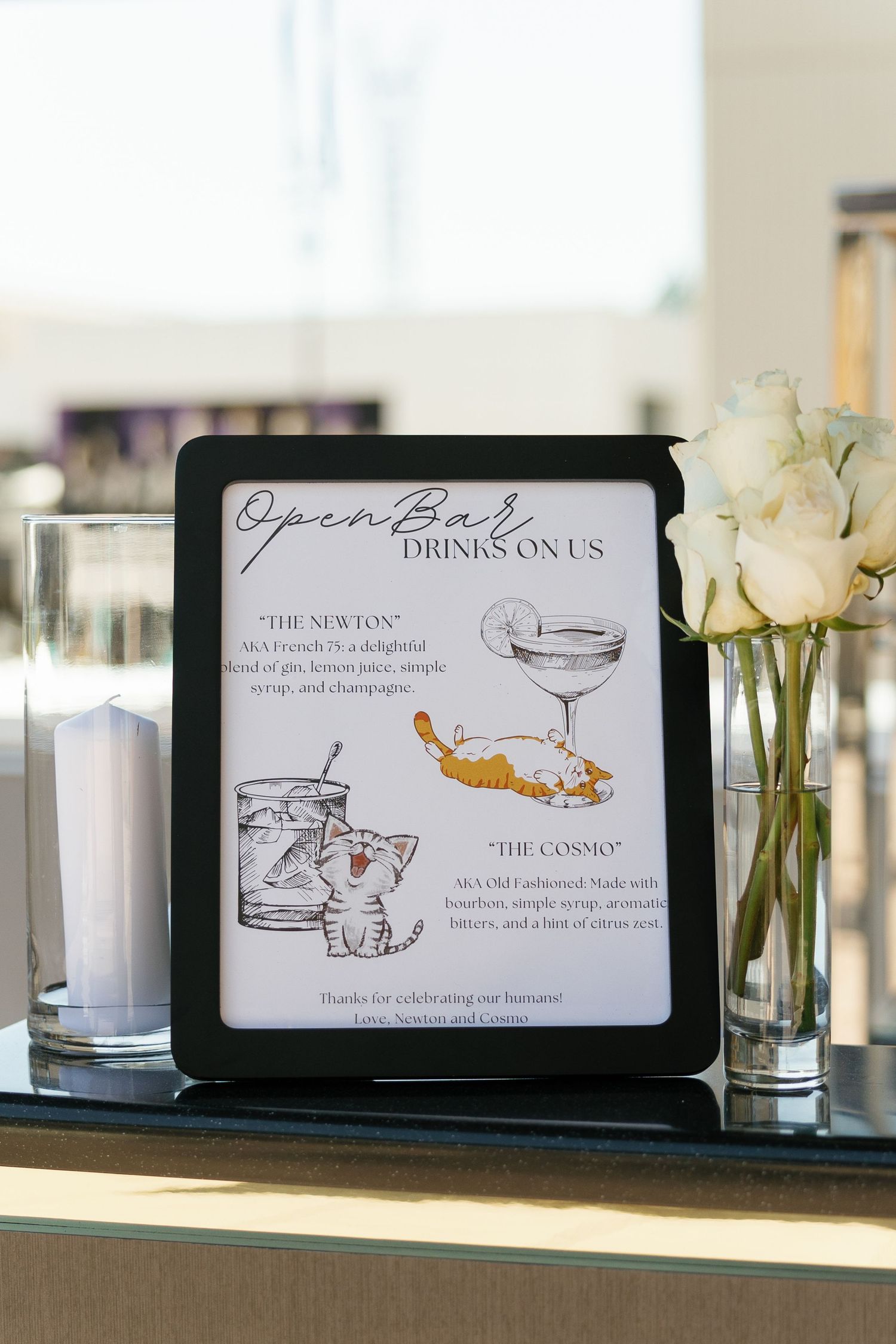 A series of elegant cocktail menu cards displayed on glass shelves with white roses in vases as decor.