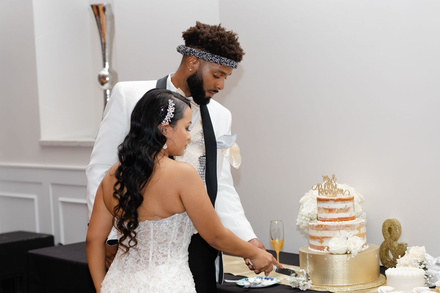 A series of wedding photos showing a couple cutting their rustic white tiered cake during their reception celebration.