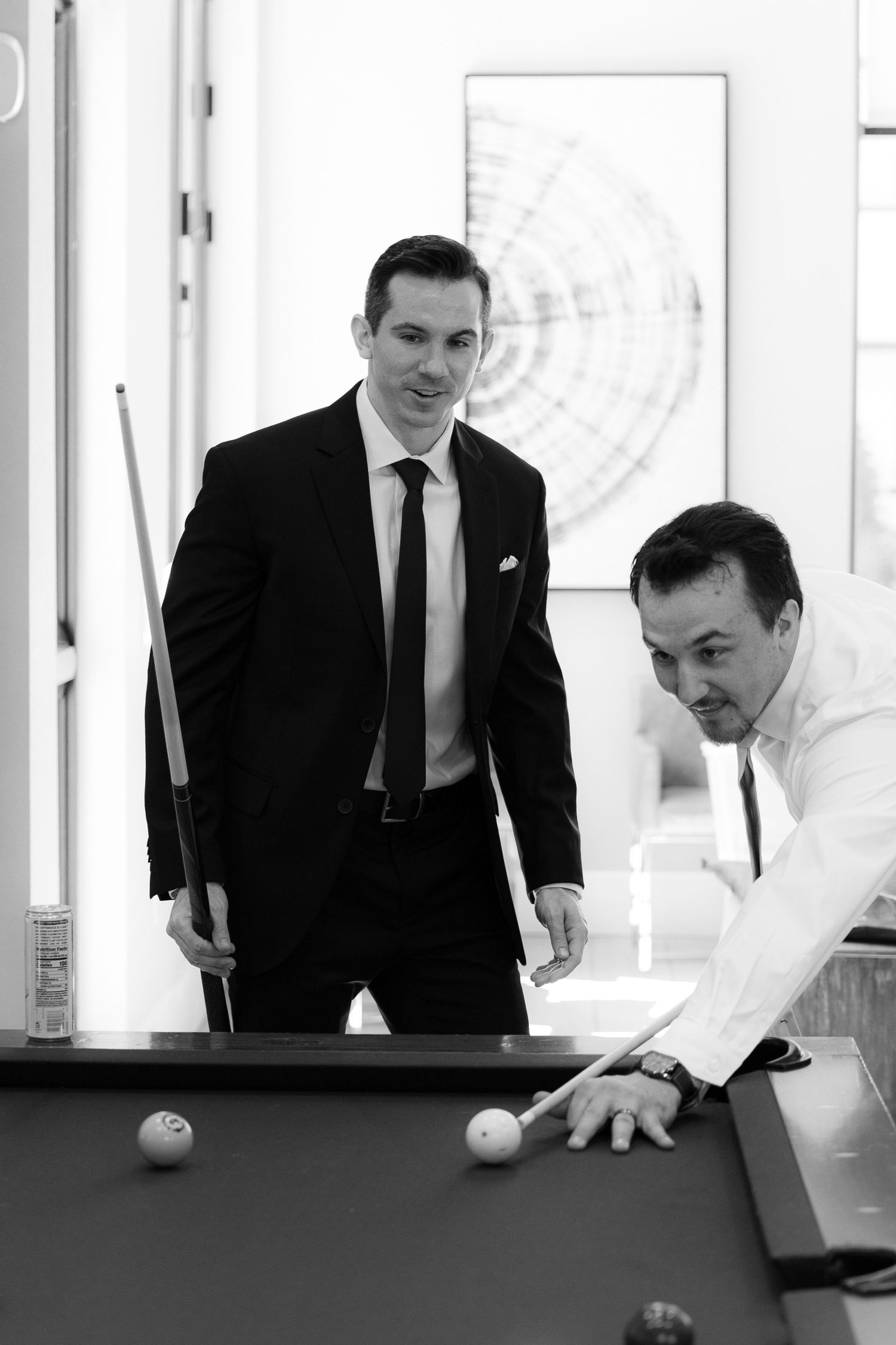 A sequence of four black and white photos showing someone playing pool at a billiards table in formal attire.
