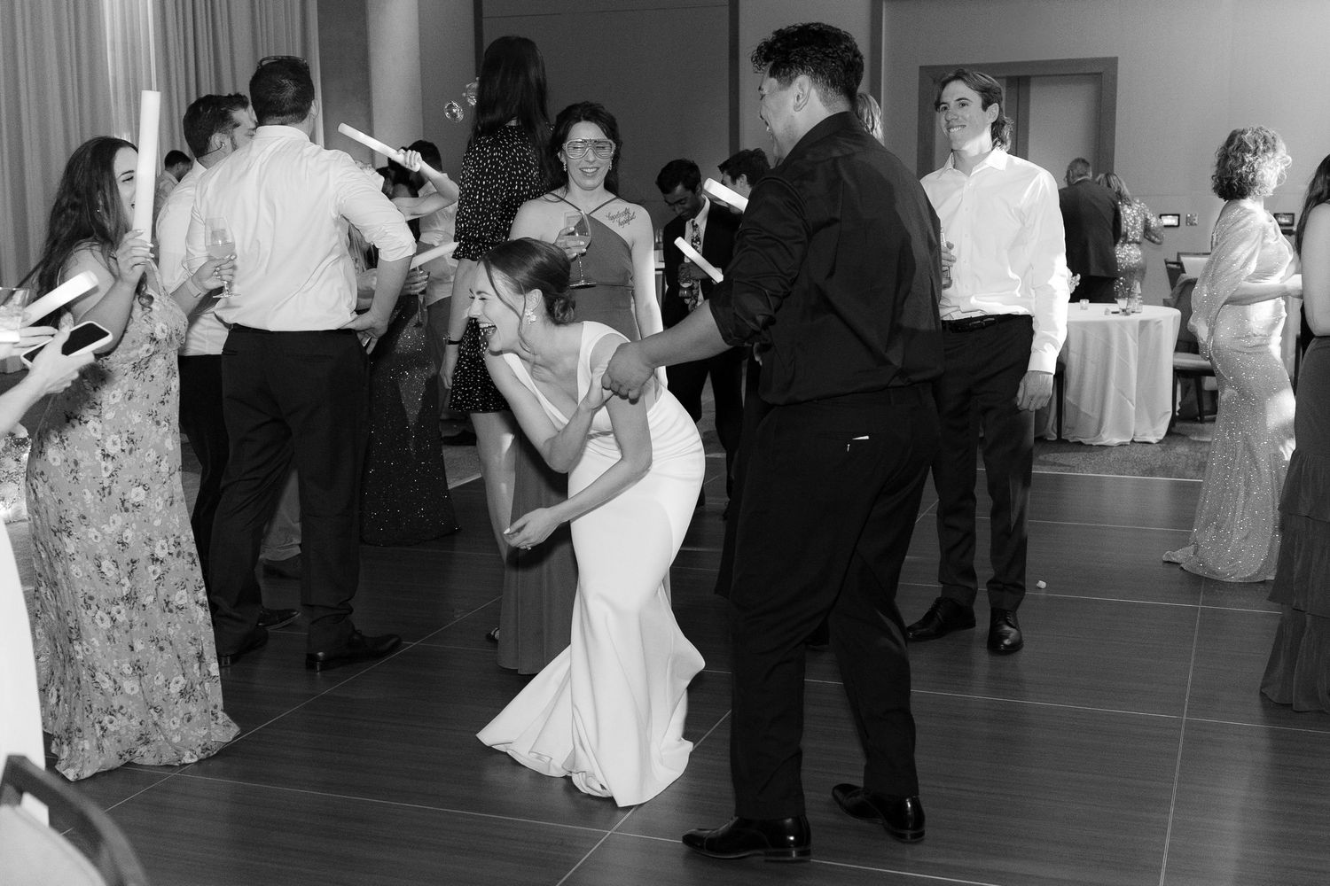 People dancing together on a dance floor at a formal event or celebration.