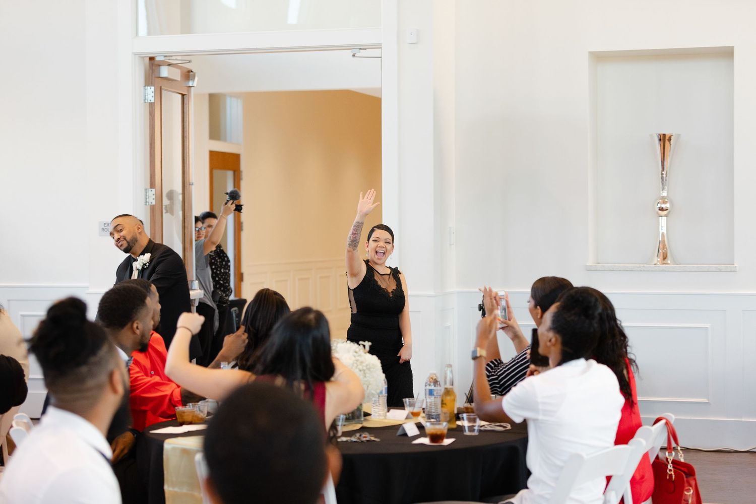 A group of people participate in a business training workshop in a bright conference room setting.