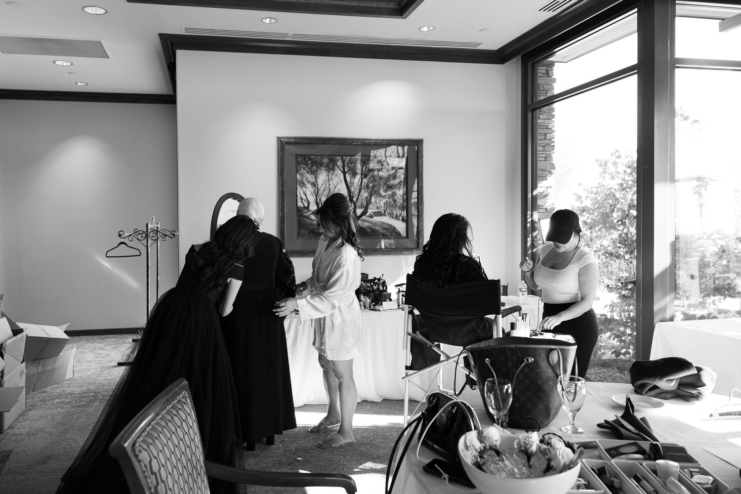 A series of black and white photos showing people working at desks and computers in an office environment.
