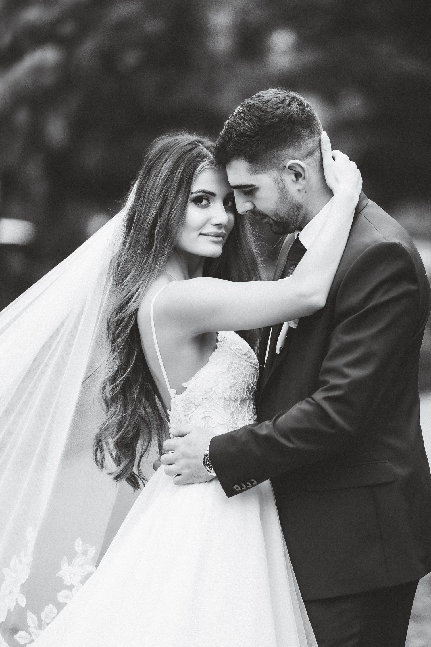 A romantic black and white wedding photo series showing tender moments between newlyweds.