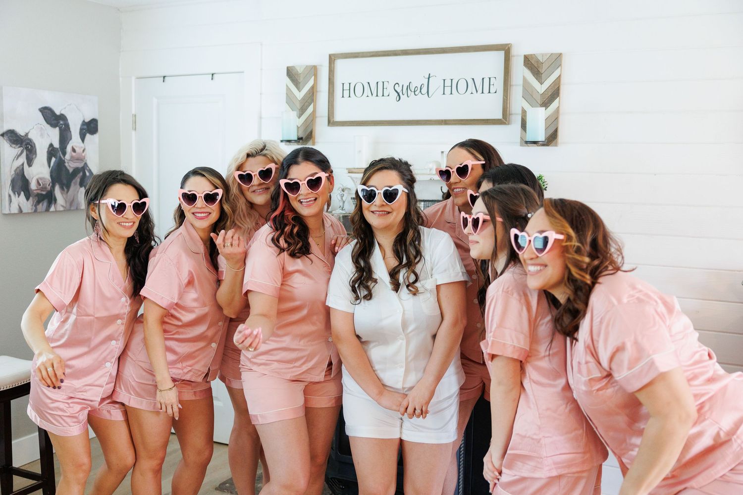 Group wearing matching pink robes and sunglasses pose together in a fun photo collage.