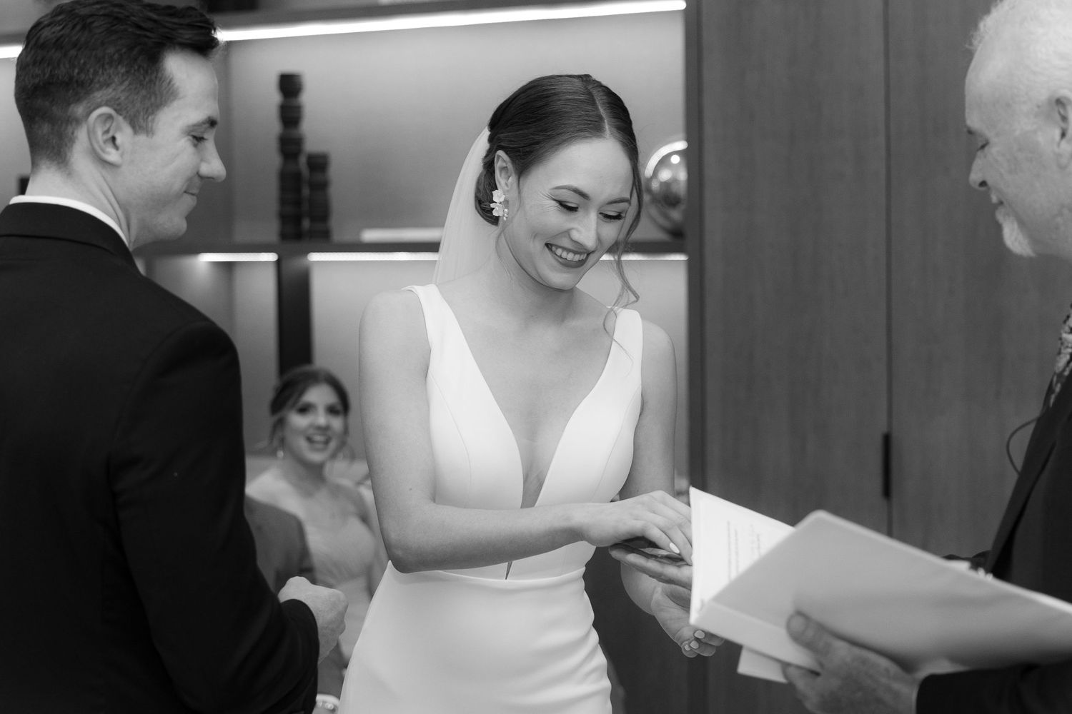 Black and white photo collage showing intimate wedding moments with couple and guests during reception celebration.