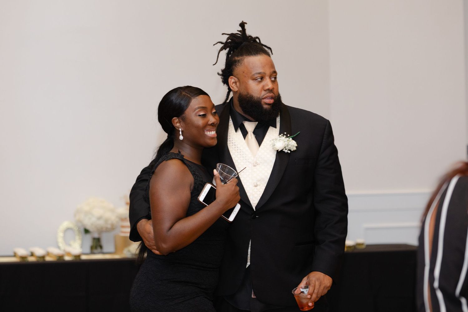 A couple shares a romantic moment during their wedding reception while dancing and embracing.