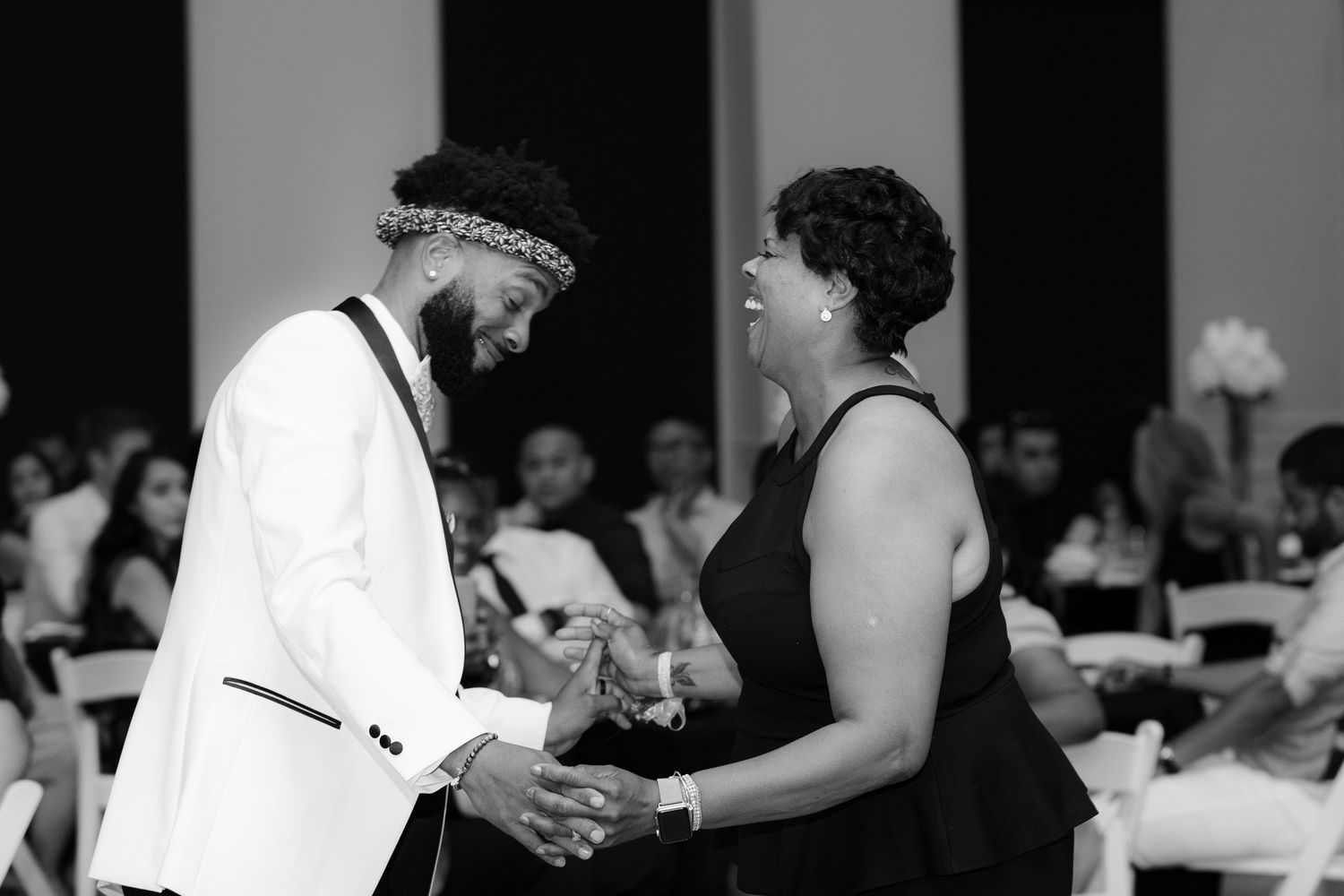 Black and white photo showing couples dancing together at a formal event.