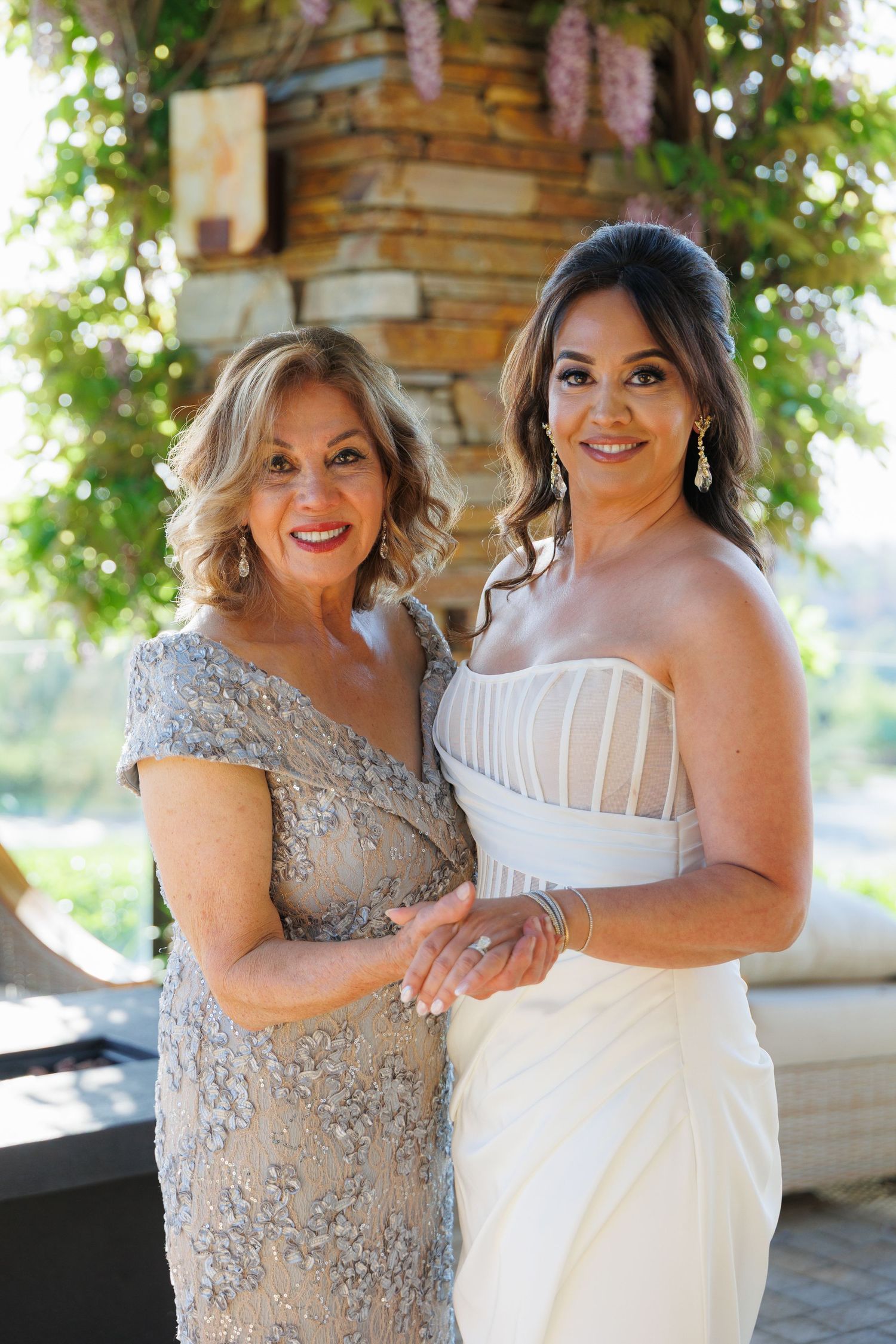 Two women in formal attire share joyful moments together in a series of outdoor photos.