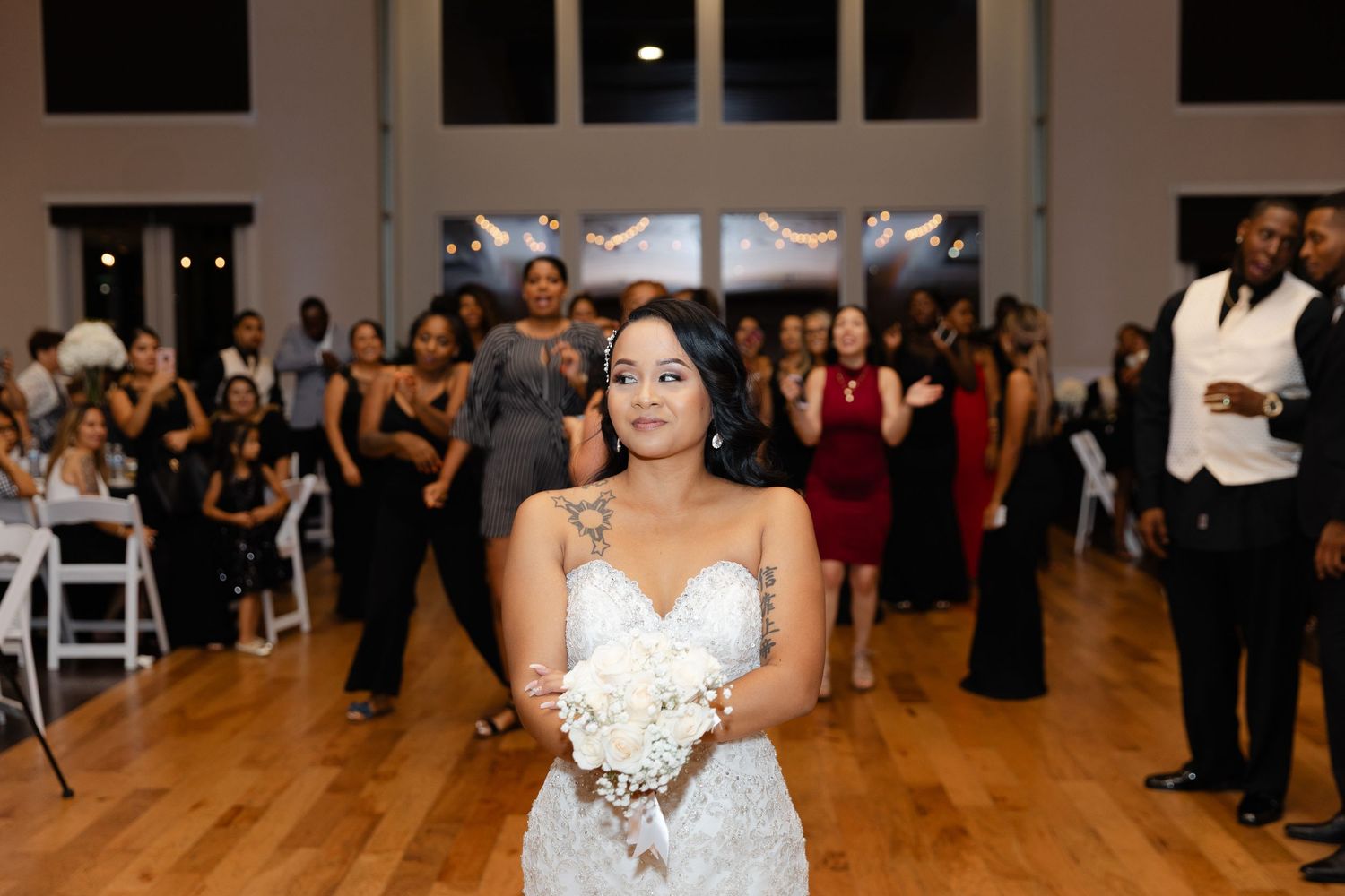 A wedding reception dance floor with guests celebrating and dancing in an elegant indoor venue.