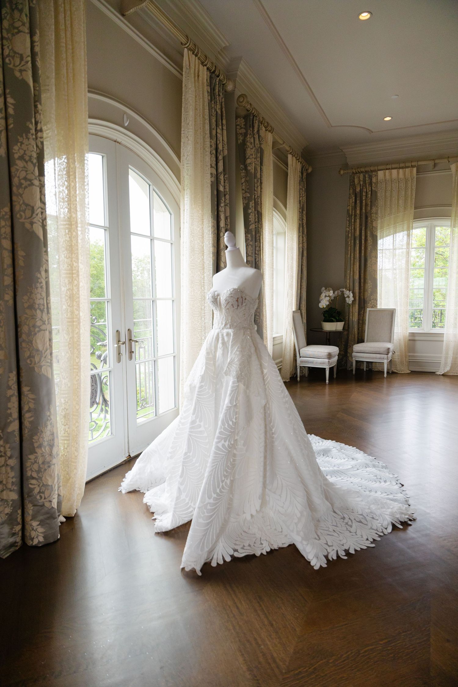 A series of wedding dress photos showing a white lace gown displayed in a bright sunlit room with arched windows and wood floors.