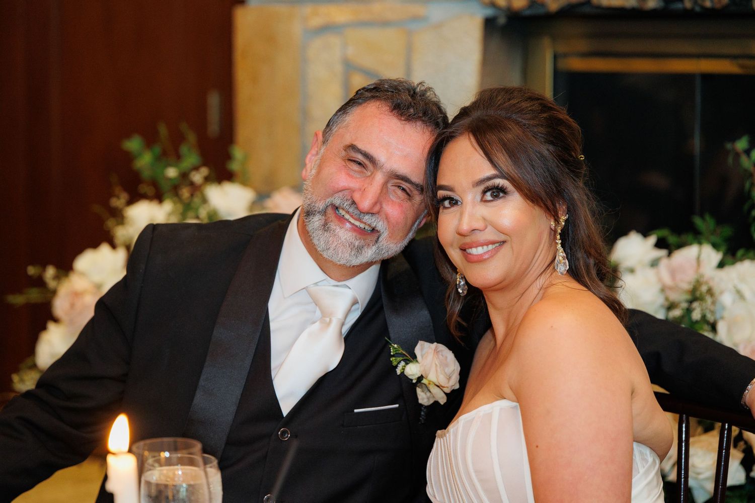 A bride and groom share joyful moments together in a series of candid wedding photos with elegant decor.
