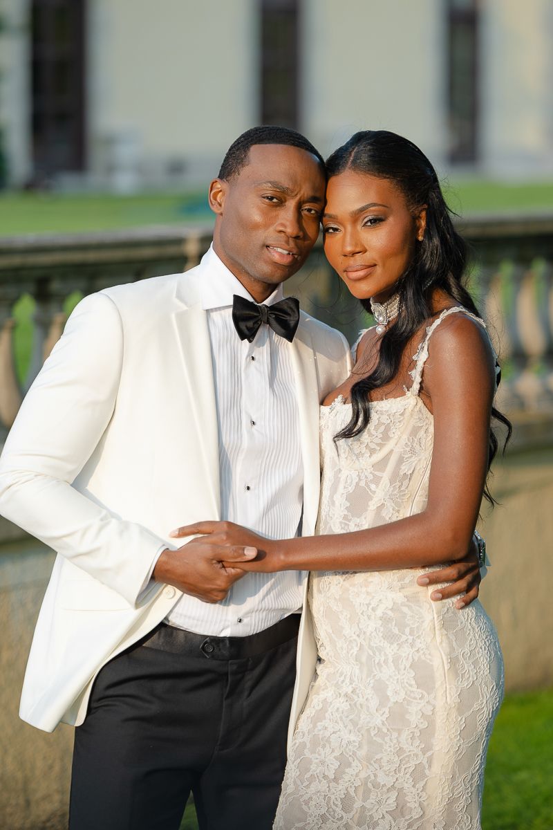 A couple in formal wedding attire embrace romantically on their special day.