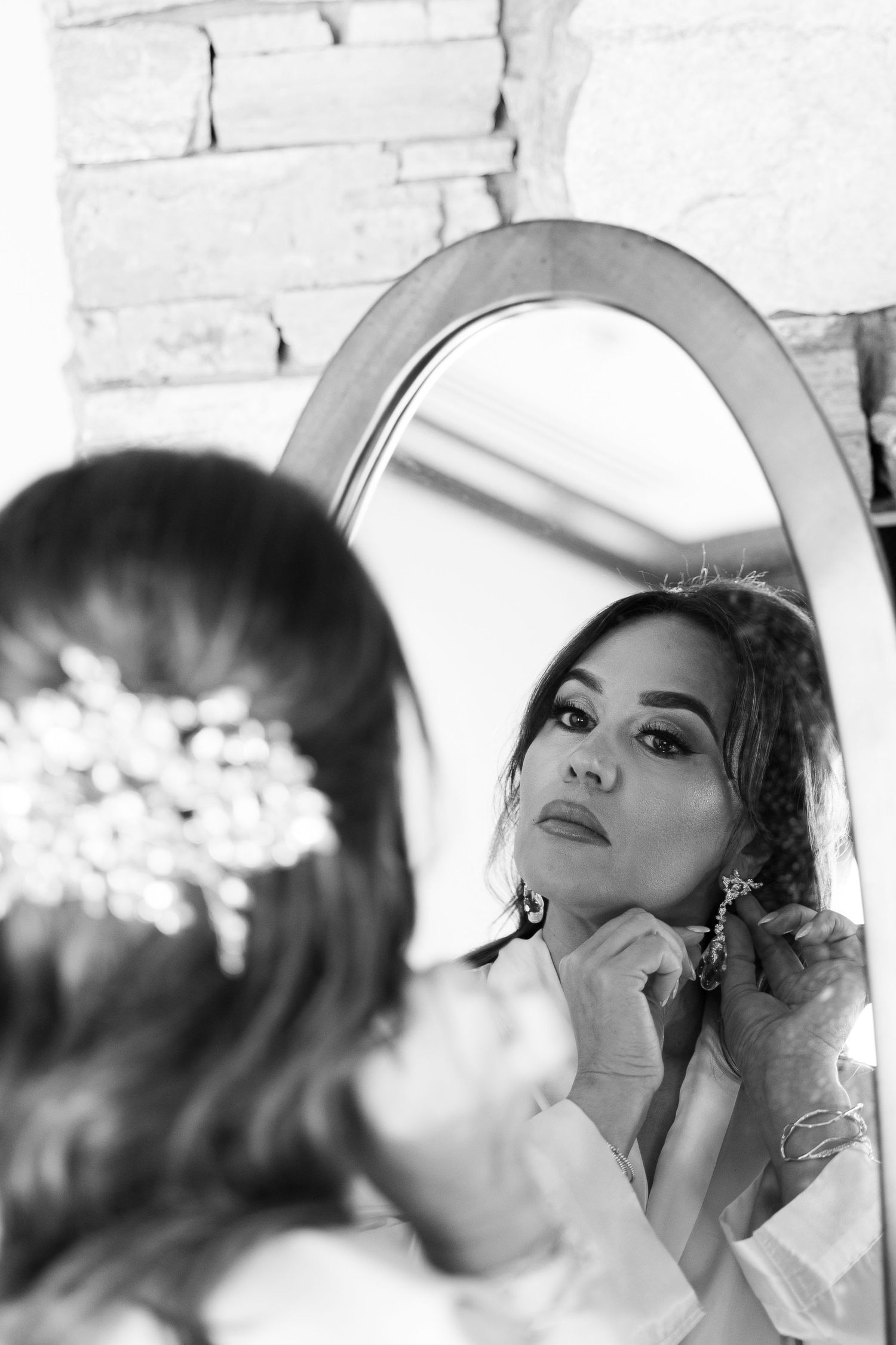 Black and white sequence of makeup application reflected in a vintage-style mirror.
