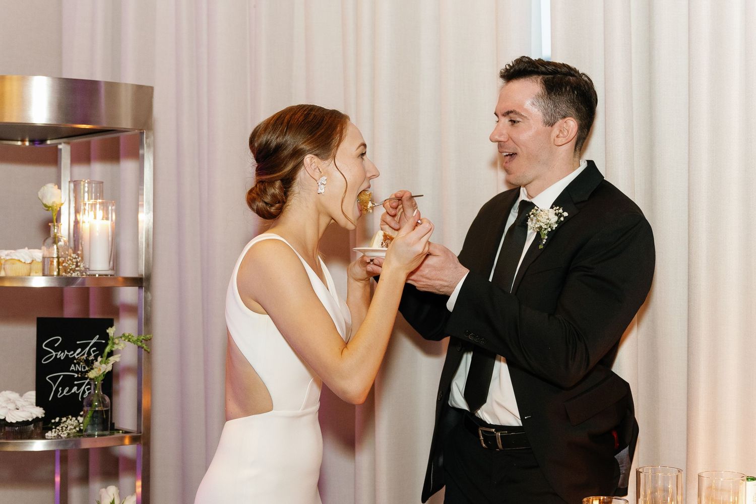 A bride and groom share their first dance together at an elegant wedding reception venue.
