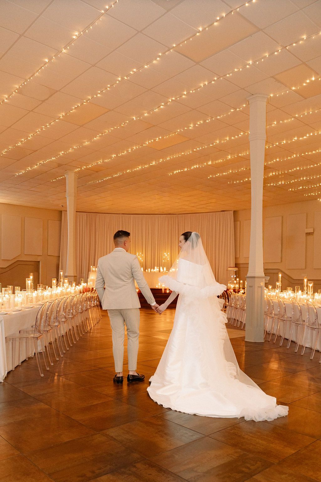 Wedding venue decorated with string lights showing progression of couple dancing in an elegant ballroom.