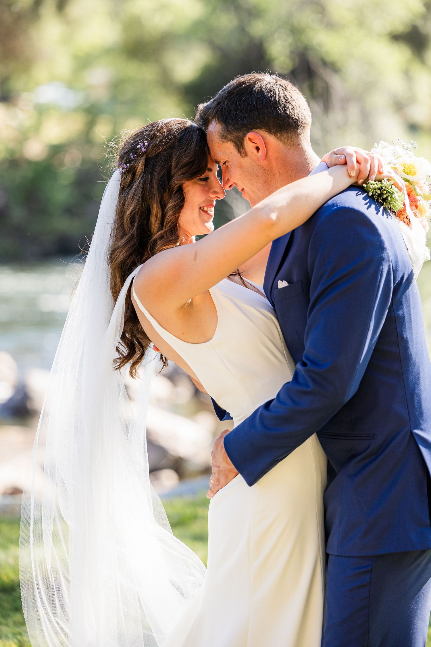 A romantic series of wedding photos showing a couple in navy and white embracing during their outdoor ceremony.