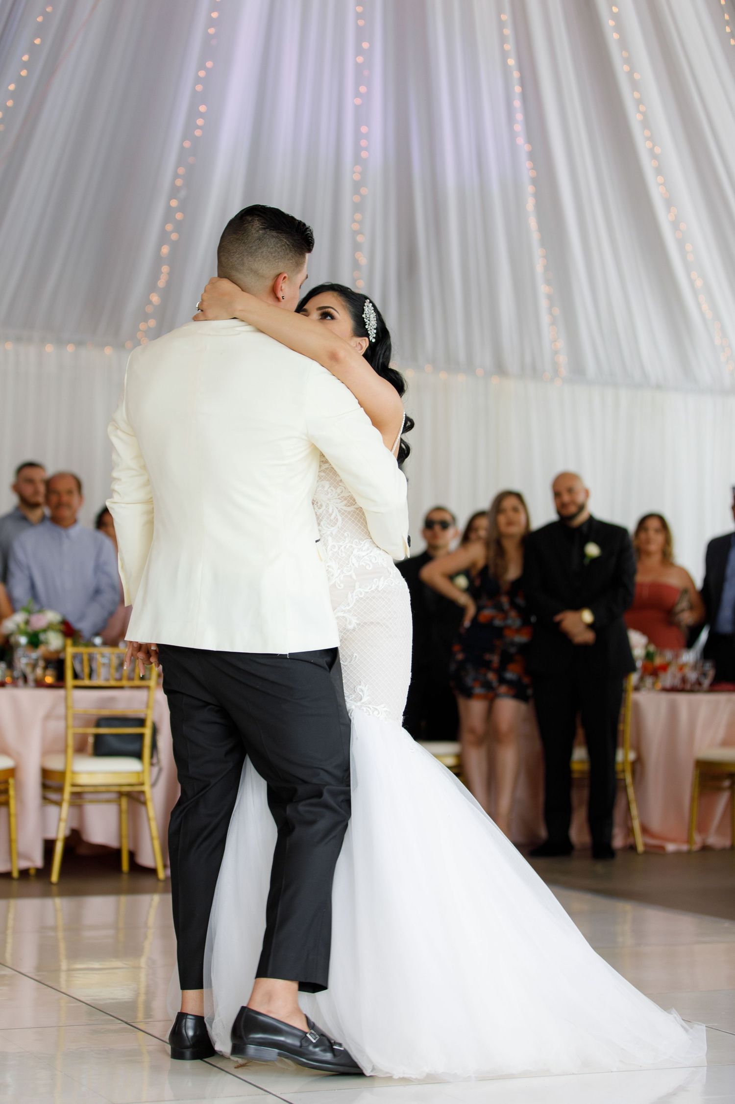 A sequence of wedding dance photos shows a couple performing a dramatic dip on the dance floor at their reception.