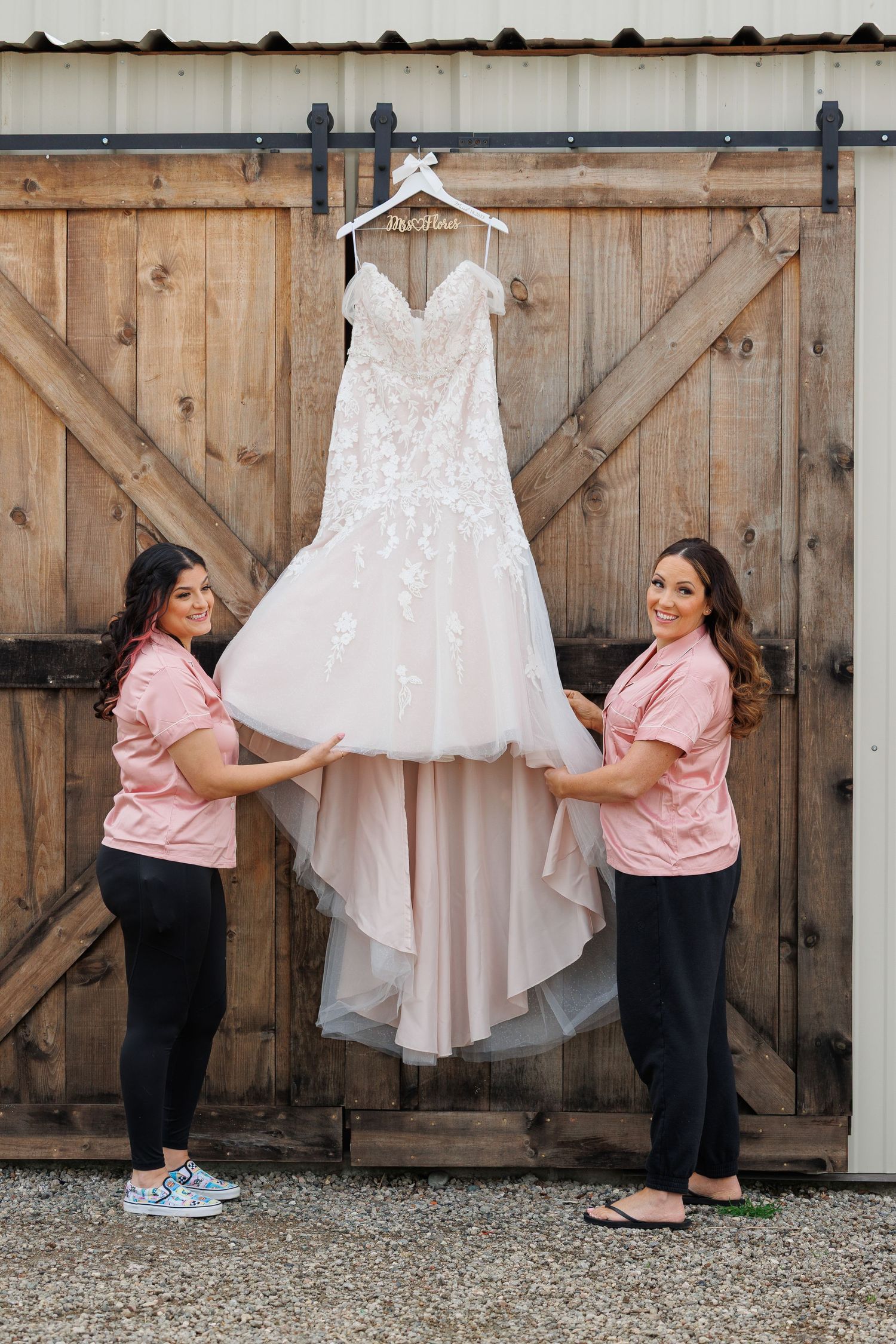 A series of photos showing a wedding dress being displayed against a rustic wooden barn door backdrop.