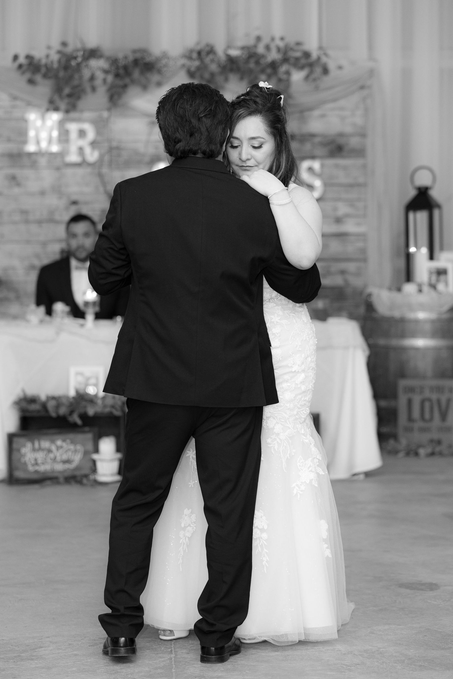 A sequence of black and white wedding dance photos showing a couple sharing a tender moment on the dance floor.
