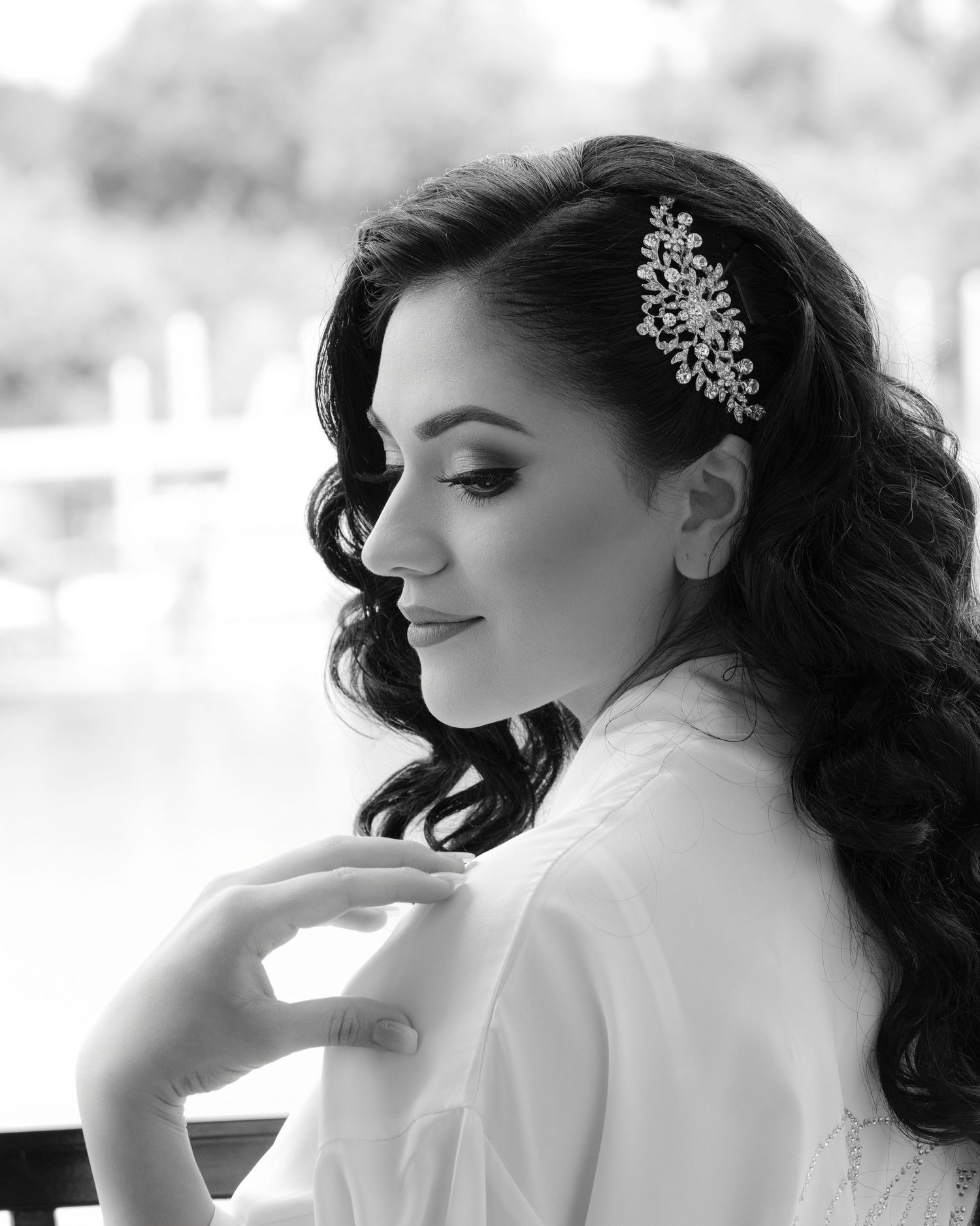 Black and white bridal portraits showing elegant hair styling and delicate jewelry details in a romantic style.