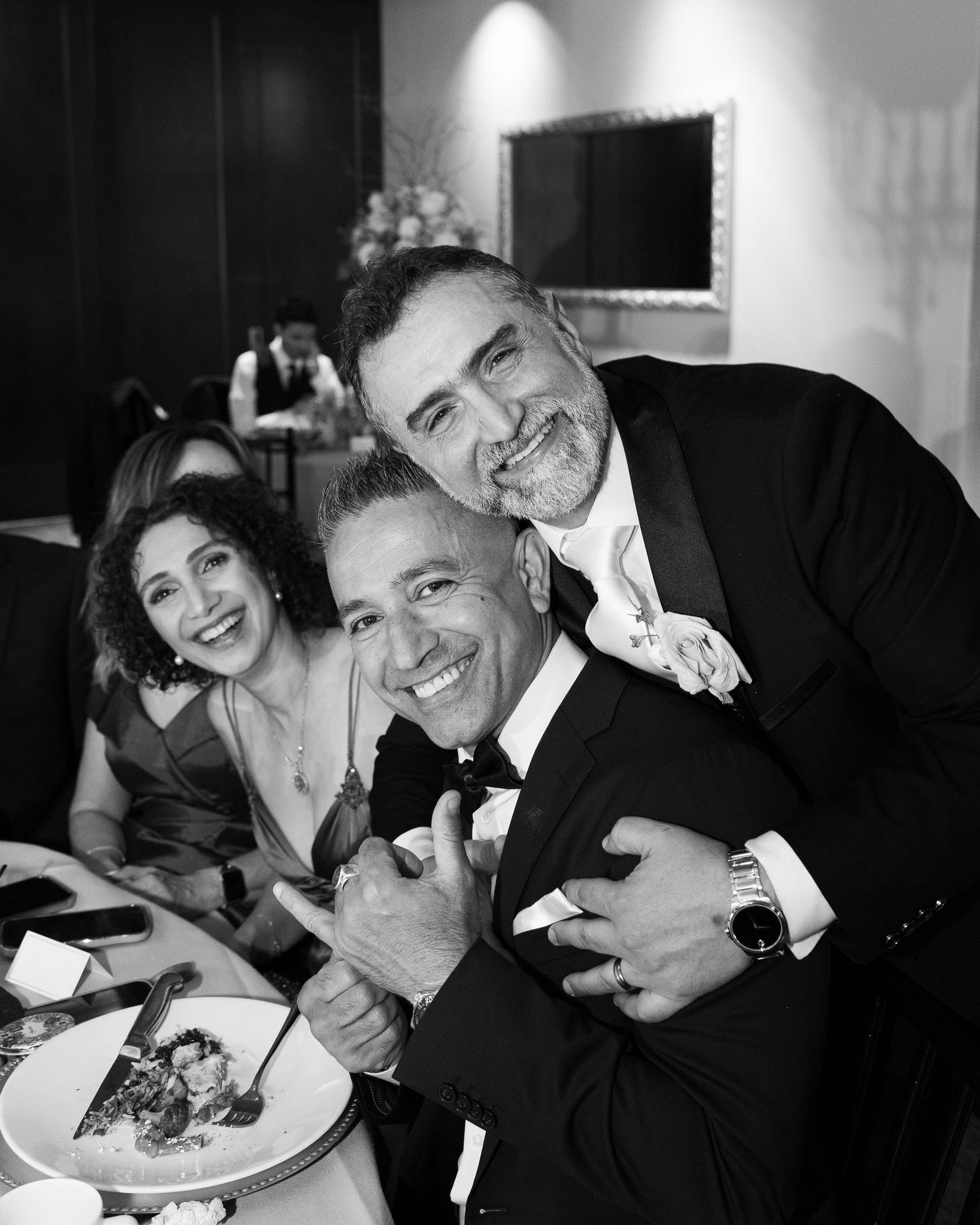 A black and white collage of candid moments showing people laughing and enjoying themselves at what appears to be a social event.
