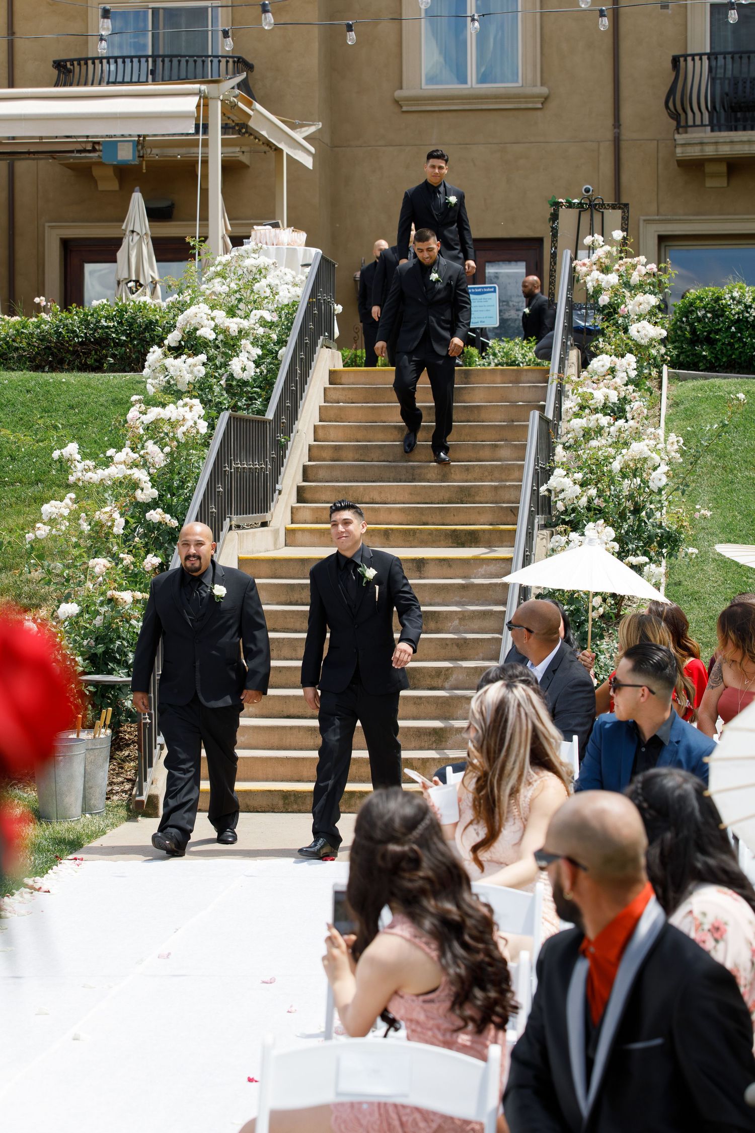A series of four connected photos showing a wedding party gathering on outdoor steps with police officers present.